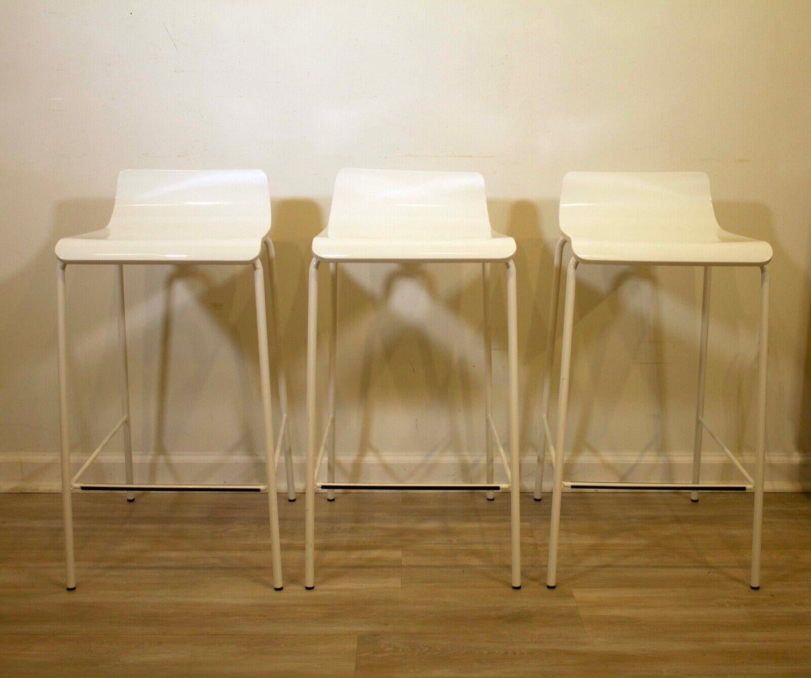 These sleek and stylish bar stools are the perfect addition to any modern kitchen or dining room. The white finish is both sophisticated and timeless and they feature a black foot rest. Perfect for any contemporary designed space! Some scruff marks,