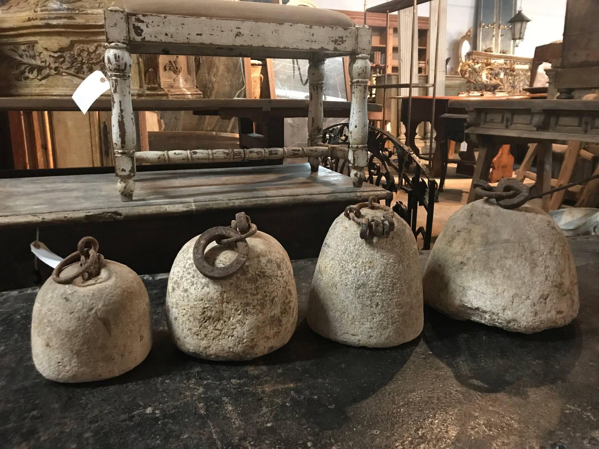 A terrific set of four various sized Spanish 17th century bell tower clock counterweights in stone and iron. A wonderful collection to enhance any tabletop, counter top or bookcase. The counterweights measures largest to smallest: 10
