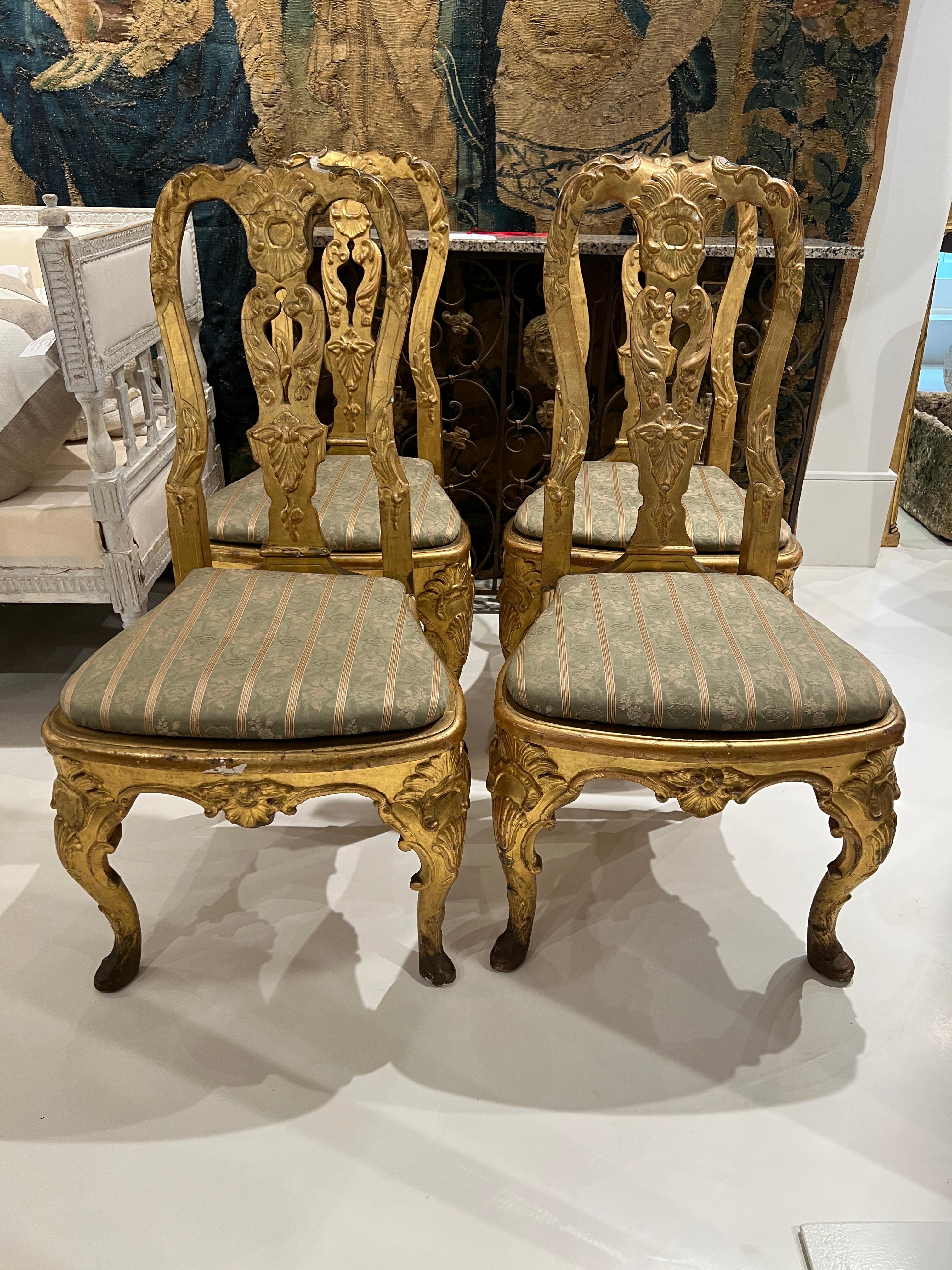 Four elegant matching side chairs with cabriole legs. Heavily gilded. Purchased in Lucca, Italy.