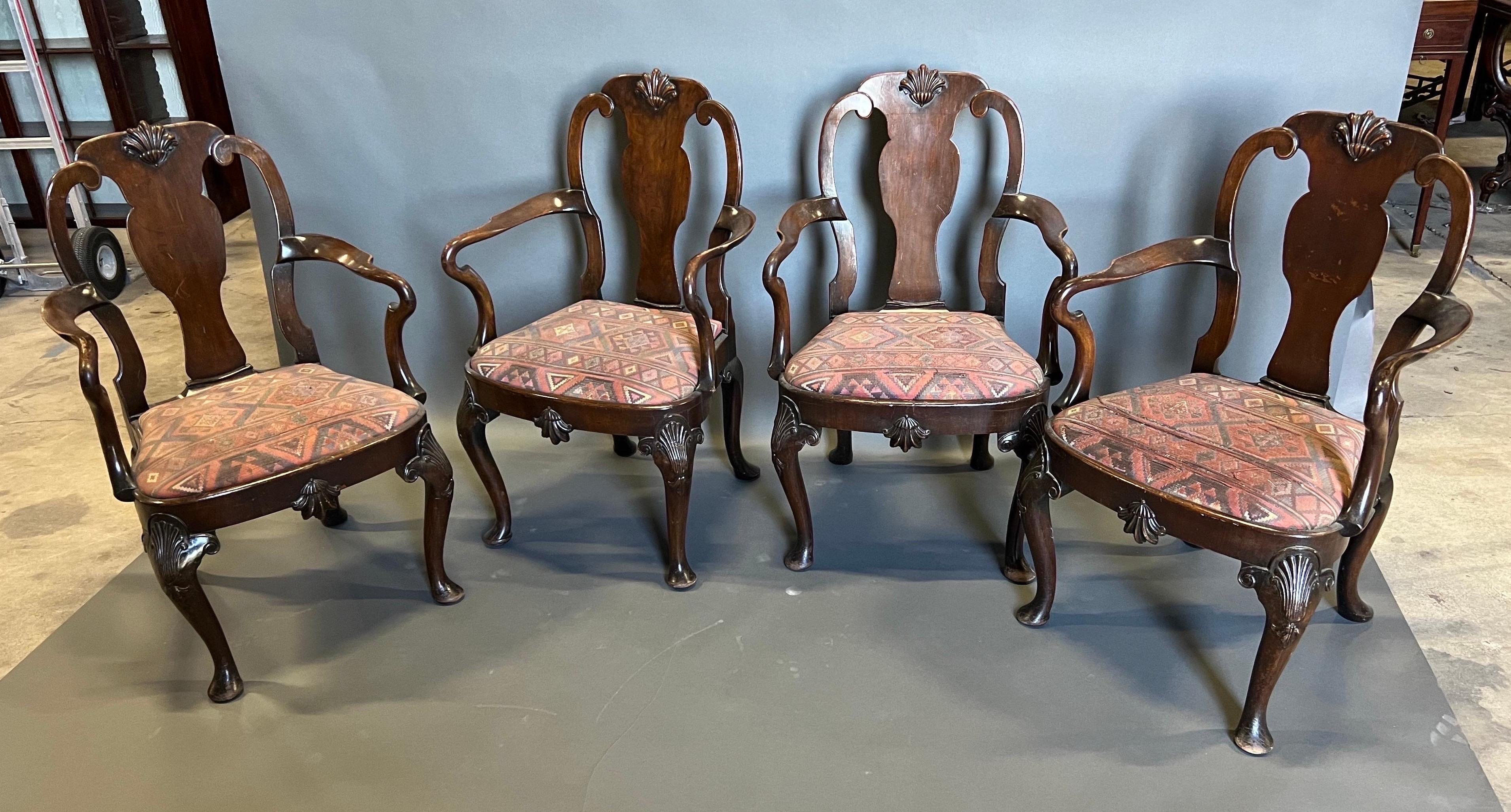 Great set of 4 18th century Queen Anne walnut arm chairs with pad feet and well executed shells carved into the seat rail and crest rail.