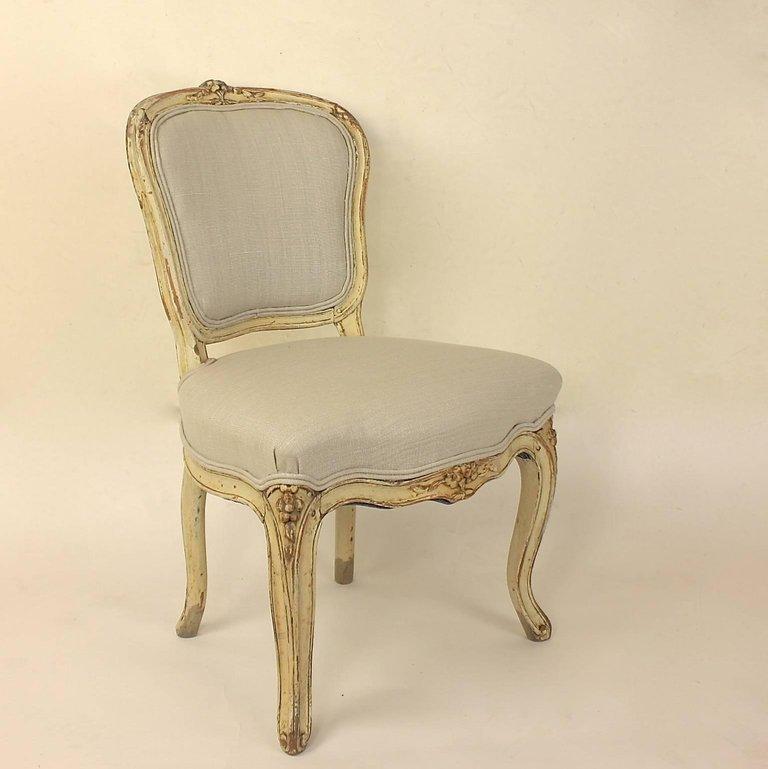Set of 4 18th Century Painted Louis XV Side Chairs, Attributed to J.B. Mouette

A set of four Louis XV painted and newly upholstered side chairs painted in a white/ cream color and covered in silver/ grey linen fabric. With a cartouche-shaped padded