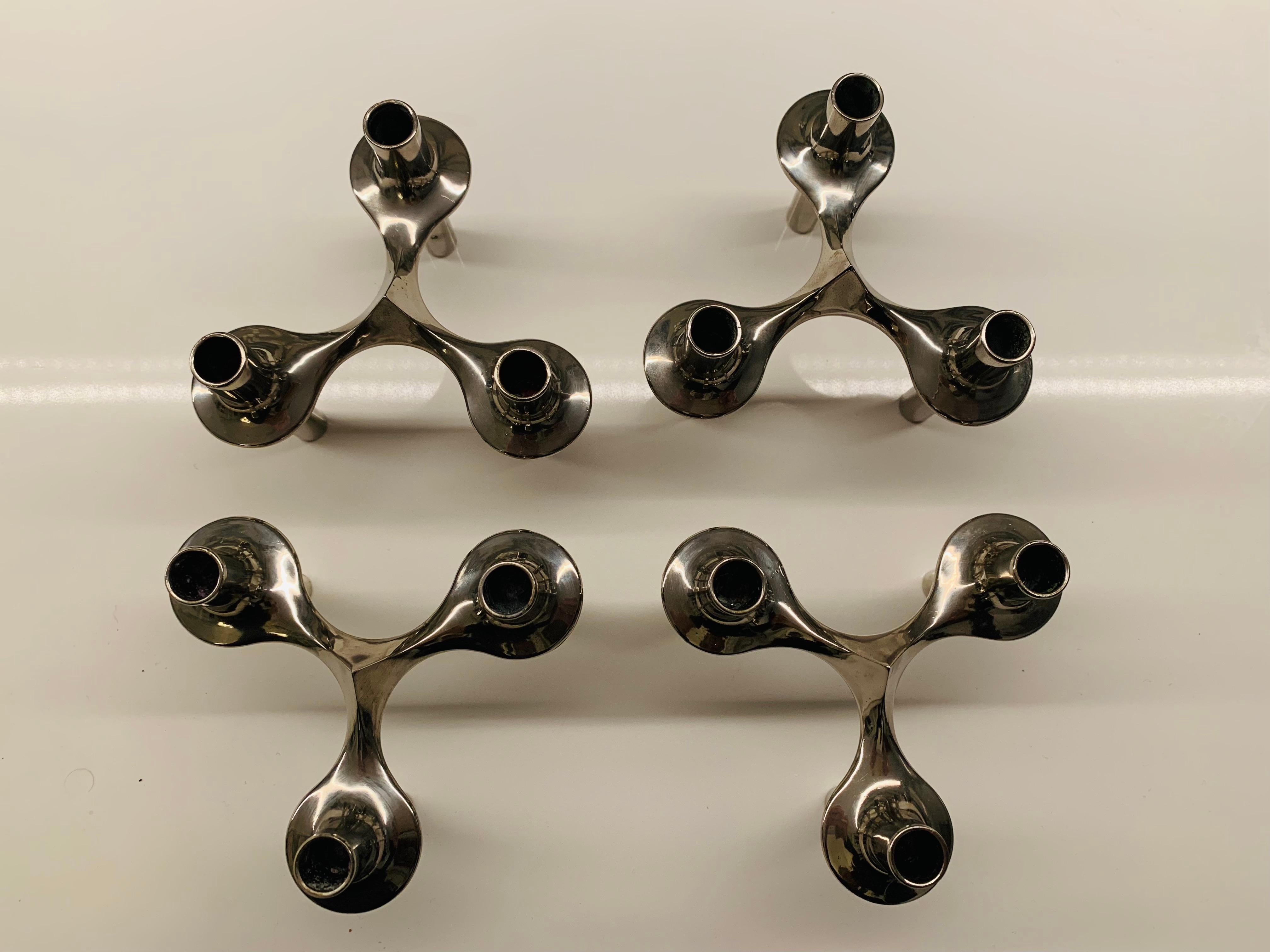 A set of 4 stackable modular organic candle holders, designed by Caesar Stoffi and Fritz Nagel during the 1960s. Manufactured by BMF (Bayerische Metallwaren Fabrik). The candle holders interlock and can be arranged in many configurations especially