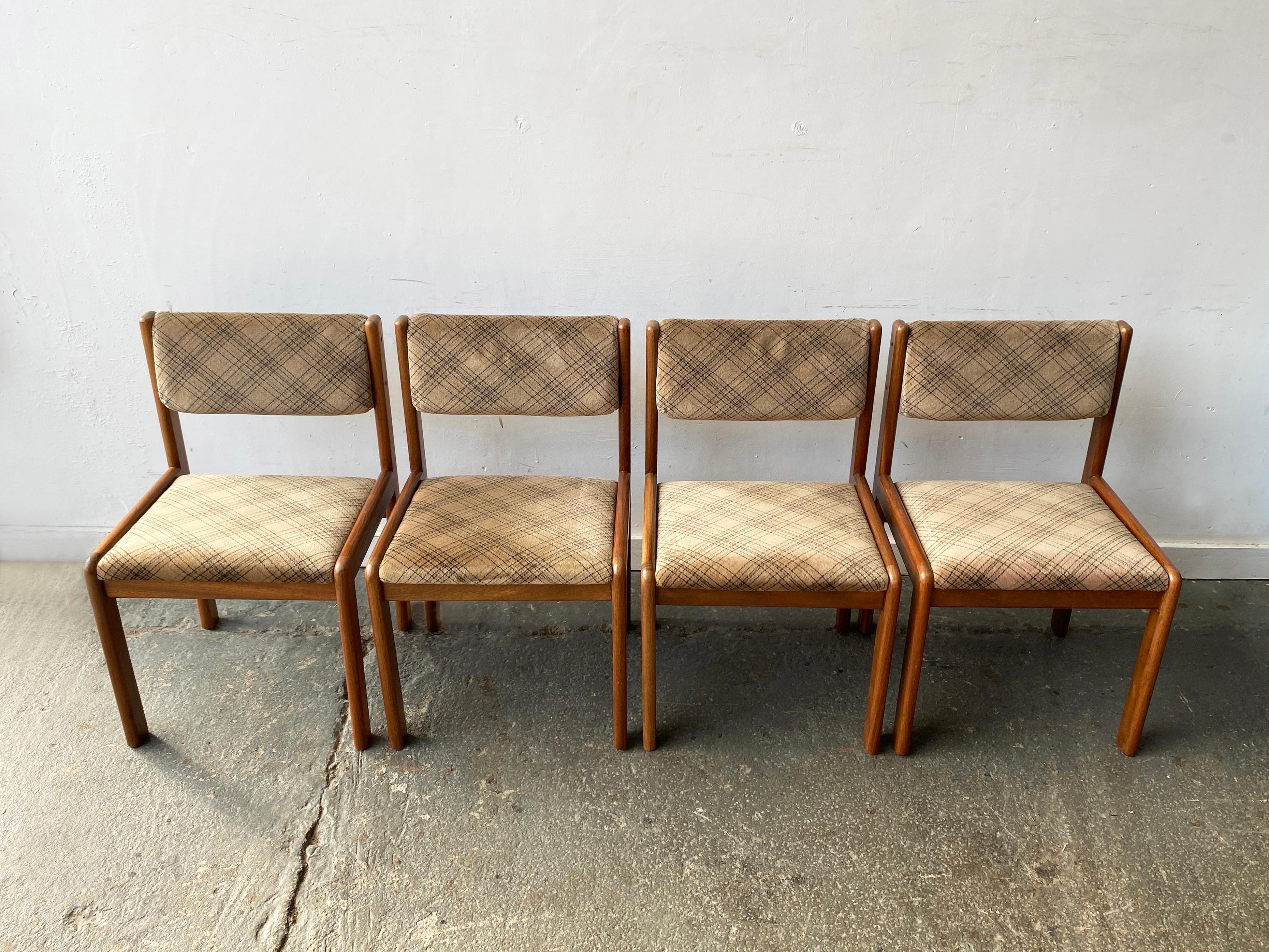 A set of four teak dining chairs by G Plan, made in the UK in the 1960s.

Strongly influenced by Danish modern design, these G Plan chairs feature clean lines, and wide solid teak frames with rounded corners. The original upholstery is a textured