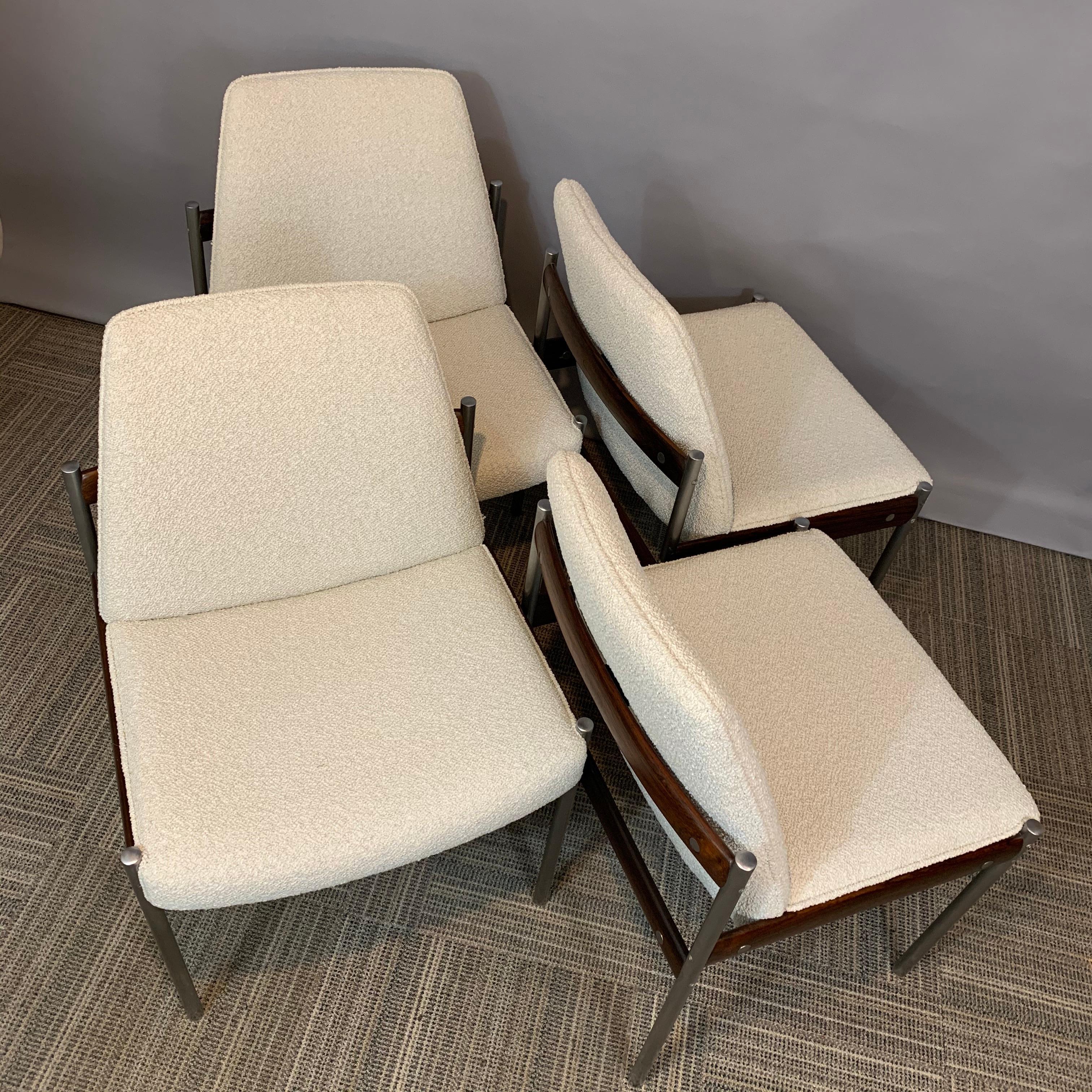 A stunning set of 4 original dining chairs designed by Sven Ivar Dysthe and manufactured by Dokka Mobler in Norway in the 1960s. The frame is manufactured from a combination of Rosewood, chrome-plated metal tubes and recently reupholstered Boucle