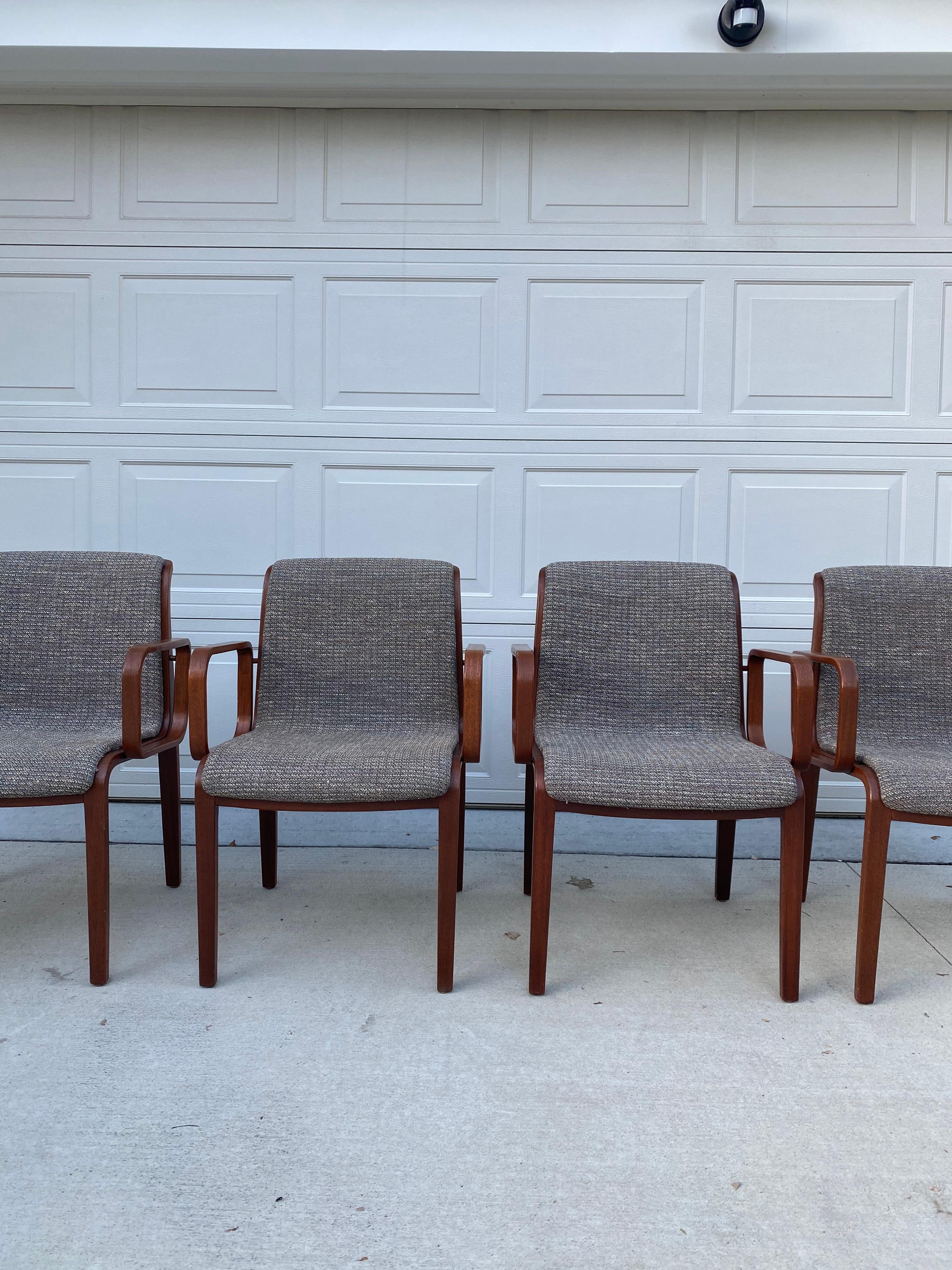 Set of four walnut 1970s Knoll Bill Stephens arm chairs in their original fabric. These chairs are in great condition considerings its age. There are some imperfections in the wood (see pictures), they have been touched up as much as possible. These