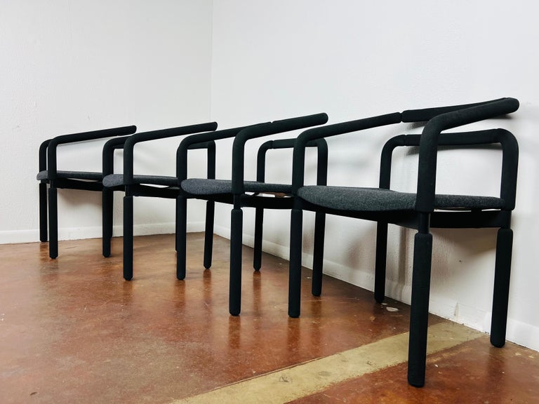 Fabulous set of four bold black armchairs designed by Brian Kane for Metropolitan Furniture (later purchased by Steelcase). These sleek vintage chairs are made of black steel encased in EPDM rubber tubing with comfortable gray woven seats and offer