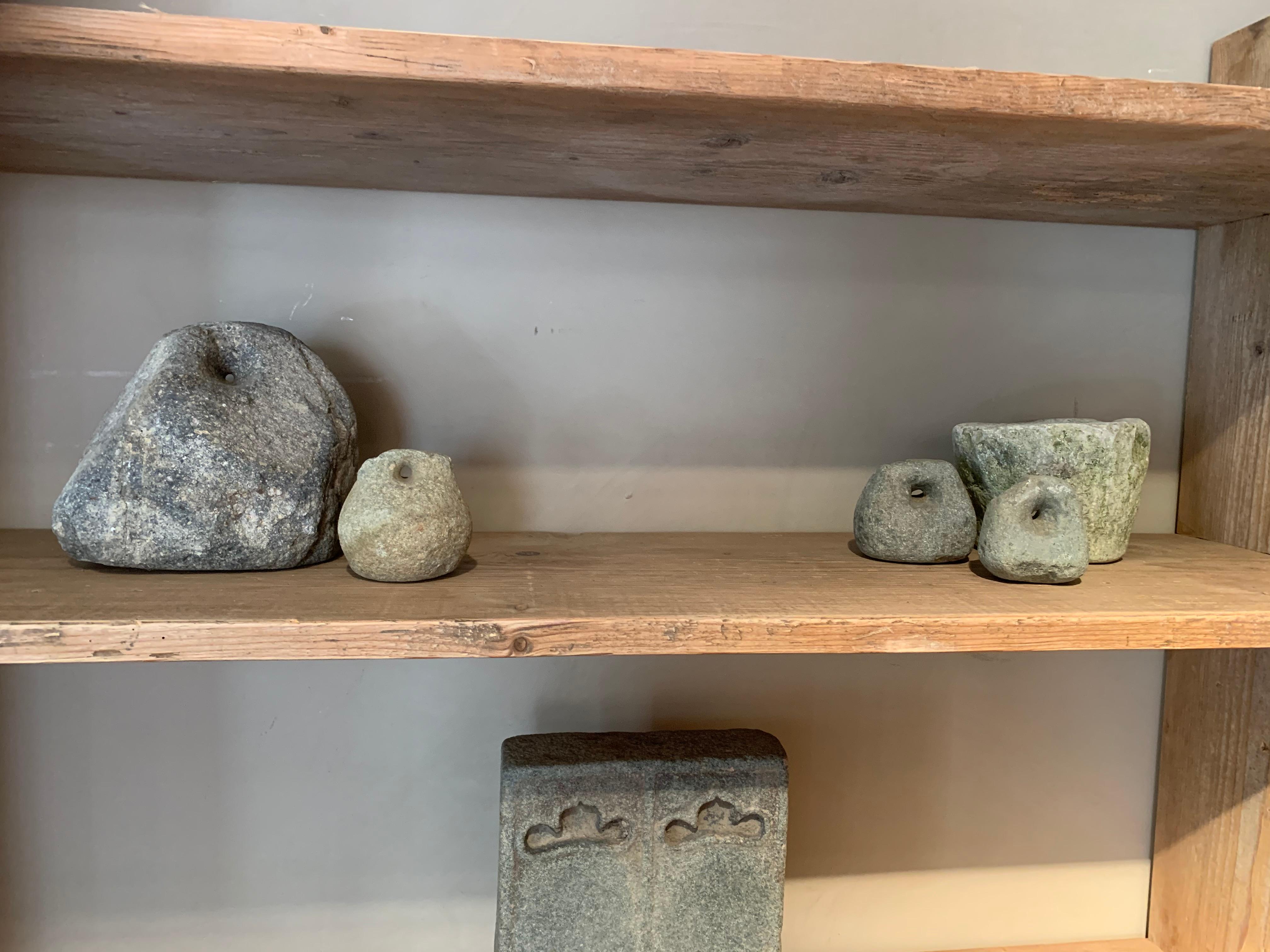 A set of 4 19th century Chinese stone weights. Originally used as counterweights in agricultural trading these stone weights have a attrictive sculptural quality and nice patina.