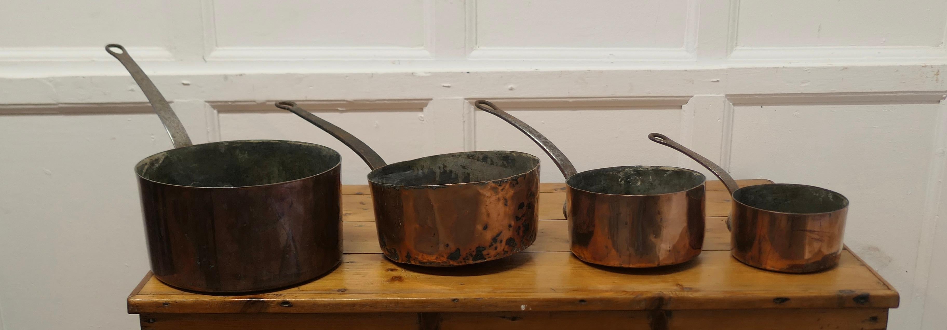 Set of 4 19th Century Copper Pots 

Set of 4 well loved and well used copper pots are tinned inside and they have cast riveted Iron handles
The pots are in good used condition, the largest is 5.5”high and 26” long including the handle
VY81
