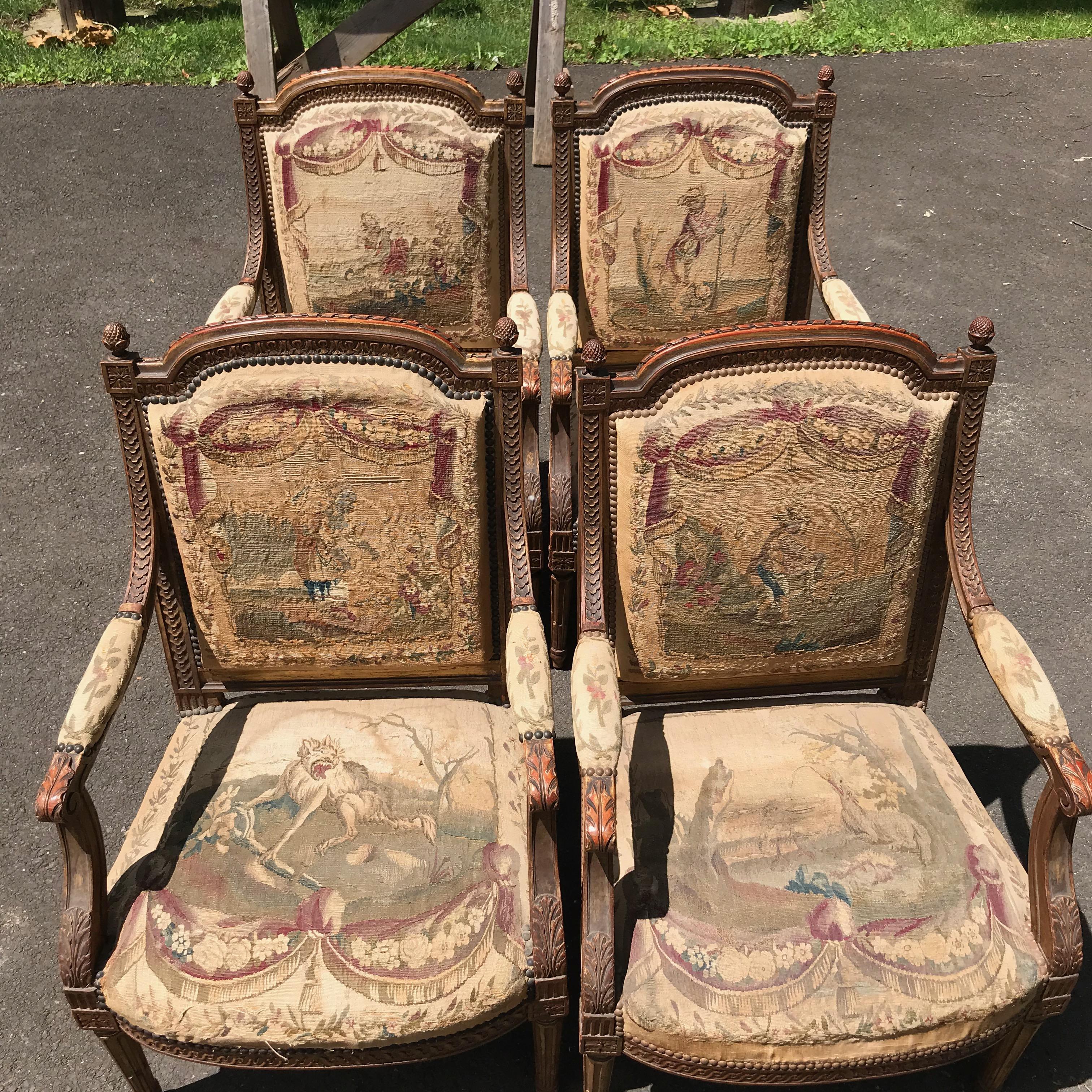 A pair of Louis XVI Fauteuils carved and gilded wood, decoration with floral motifs. Upholstered backs and seats with Aubusson tapestry, depicting La Fontaine fables (possibly from the 18th century), France, 19th century. Losses and defects.