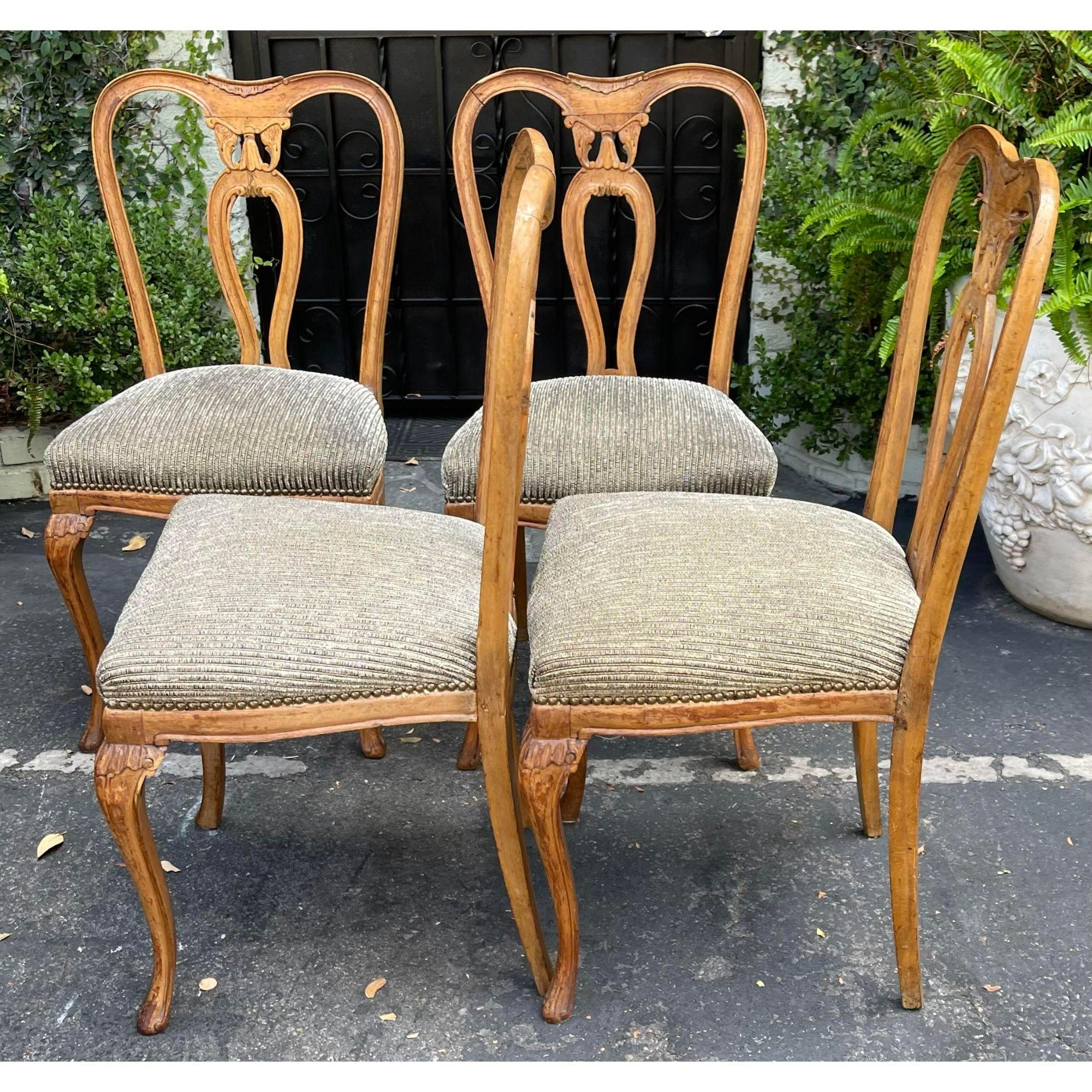 19th C Style Carved Italian dining chairs - Set of 4. This lovely set of four chairs are hand carved solid walnut and were made in Italy. Each features a chenille seat.

Additional information: 
Materials: Walnut
Color: Brown
Period: Mid 20th