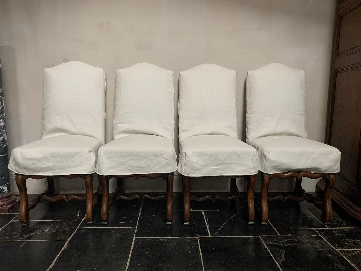 A set of 4 19th century walnut French chairs. This Louis XIV model is also known as Os de Mouton or 'Sheepclaw feet'. The wood is pegged and maualy joined and turned by hand. It has a good patina and very solid. All have a custom made losse linnen