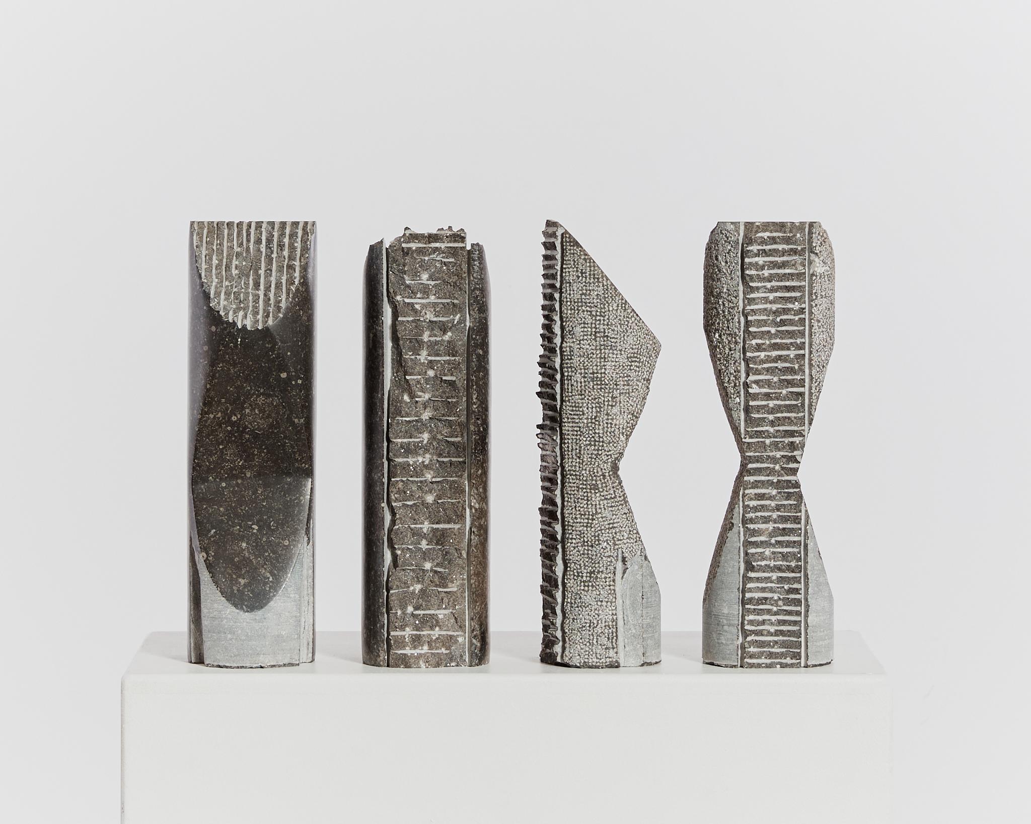 Set of 4 abstract totemic sculptures by Antwerp based Artist, Jorg Van Daele. Each from a single piece of Belgian bluestone, the works feature an array of techniques including stippling, carving and machine work. 