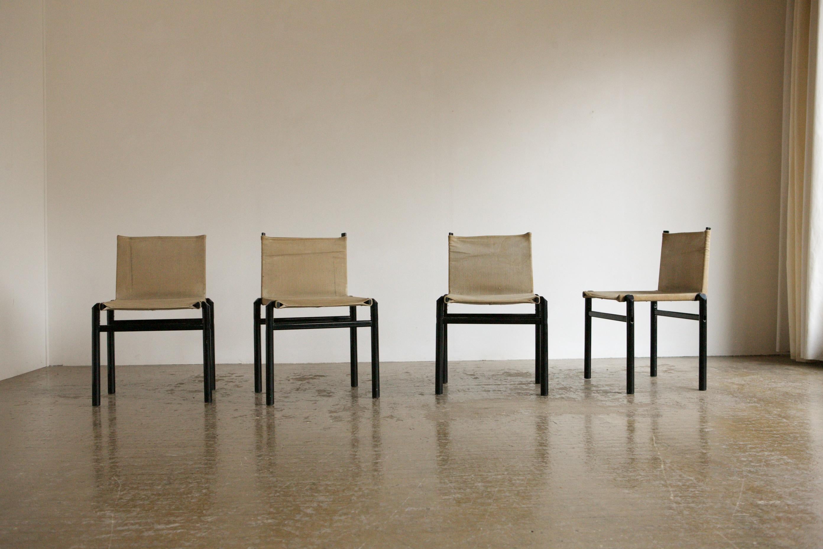 We love this neutral set of chairs in steel and canvas by the giants of 1970's Italian design, Afra and Tobia Scarpa. The Mastro chairs have a light black steel frame in black and they are upholstered with their original natural canvas. The chairs