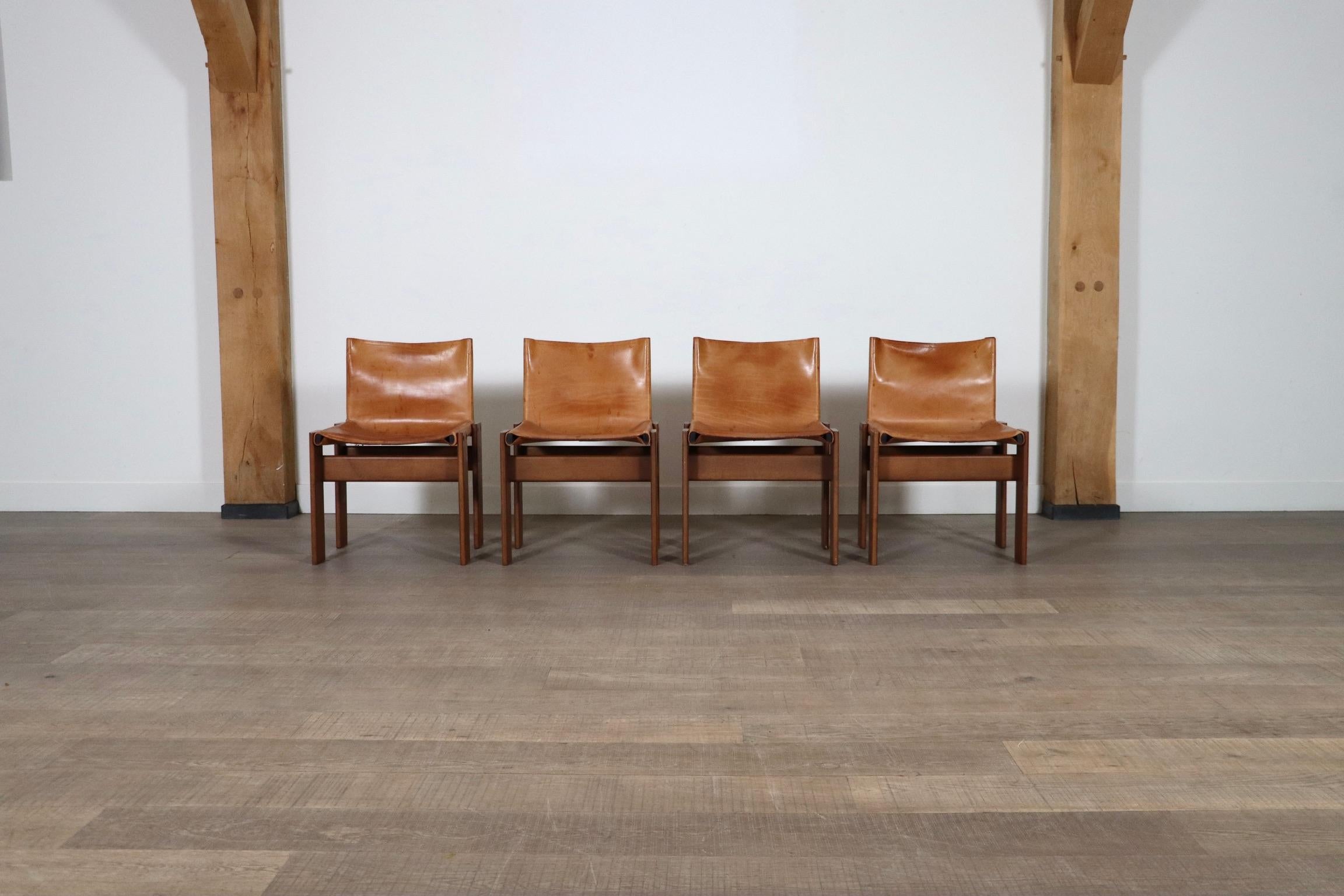 Fantastic set of 4 ‘Monk’ chairs designed by Afra and Tobia Scarpa for Molteni, Italy 1974. The sober design, after its name “Monk” is complemented with this beautiful combination of the patinated natural leather and walnut frame. When de­signing