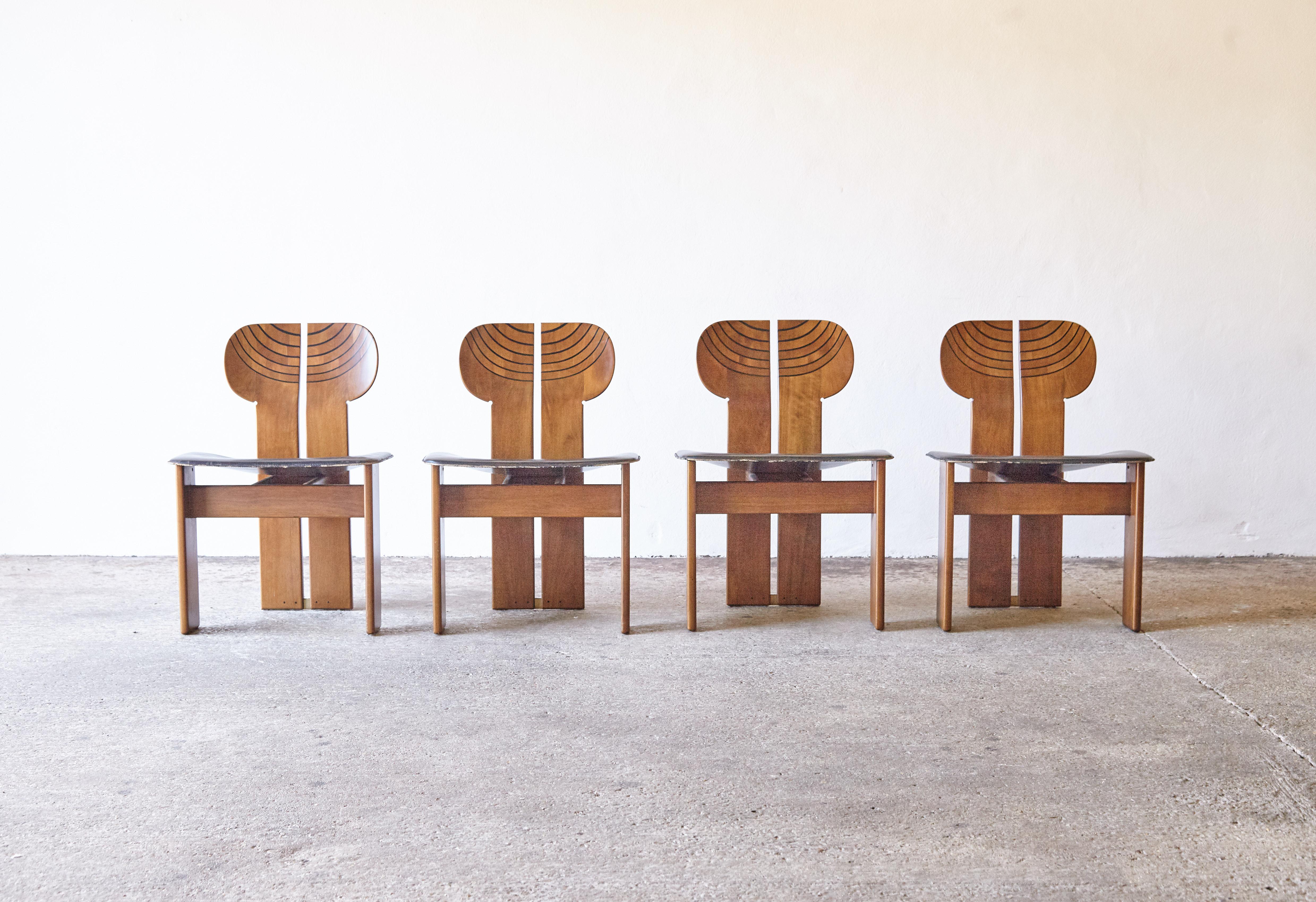 A stunning set of four Africa chairs designed by Afra & Tobia Scarpa in the 1970s, and produced by Maxalto, Italy. Walnut, burl, black leather and brass. Good original condition with normal minor age related signs of use and wear. The original