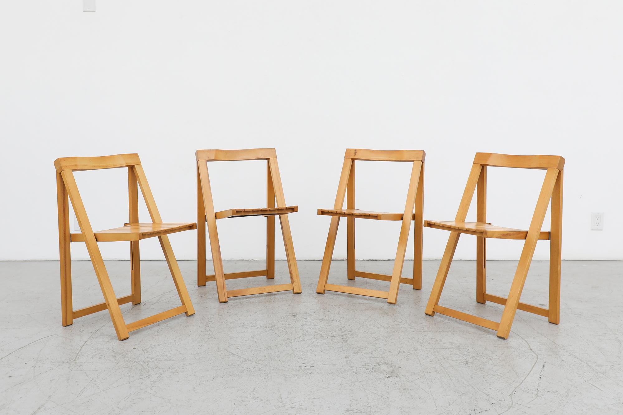 Set of 4 Aldo Jacober folding chairs for for Alberto Bazzani, 1960. Light Beech wood folding chais with space saving functionality and mid-century style. Folded they measure 18 x 1.625 x 34.875. In original condition with visible wear and chipping