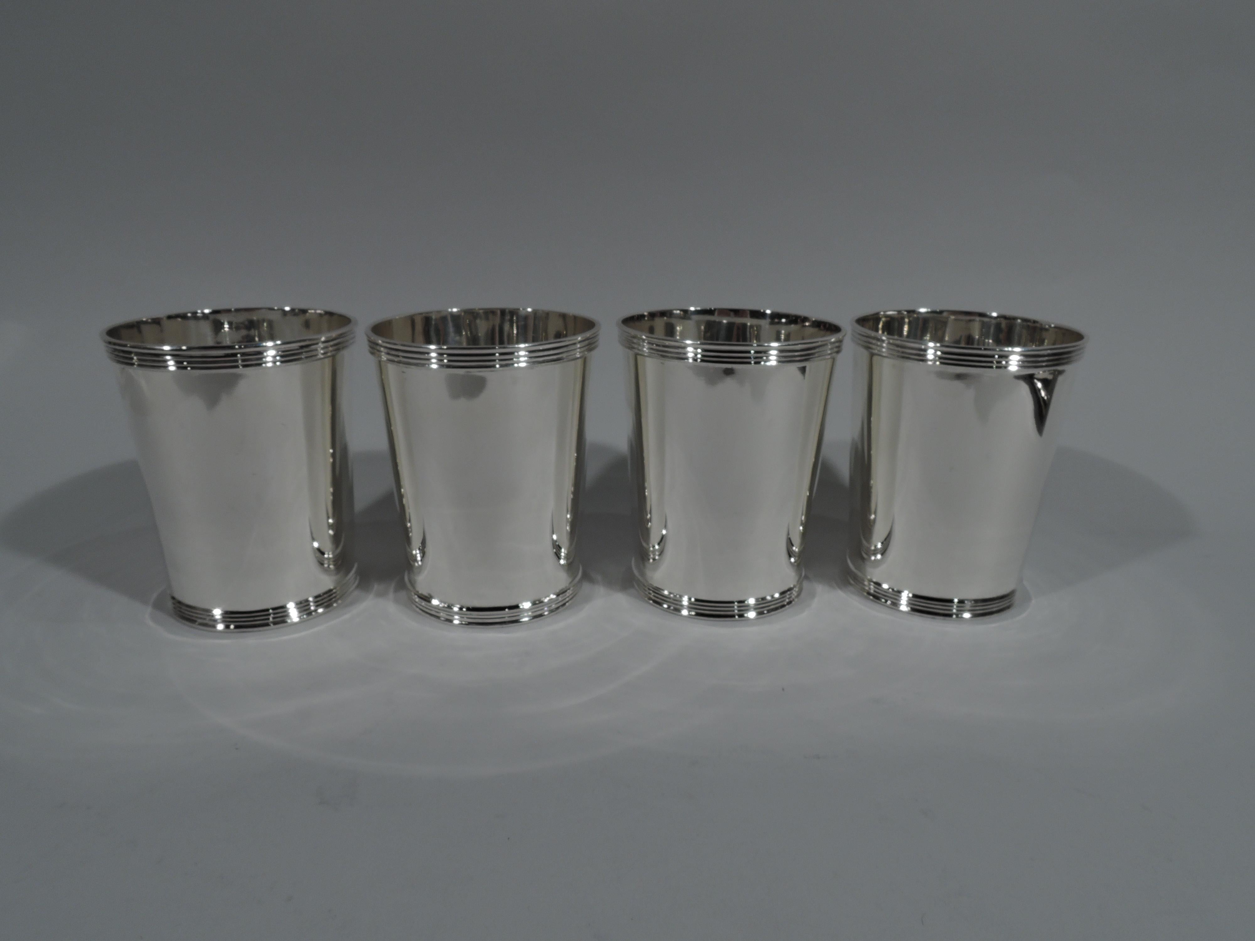 Set of 4 sterling silver mint julep cups. Made by Frank W. Smith in Gardner, Mass. Each: Straight and tapering sides and reeded rim and foot. Fully marked including maker’s stamp and no. 3759. One cup has retailer’s stamp (Caskey Jewelry Co.). Total