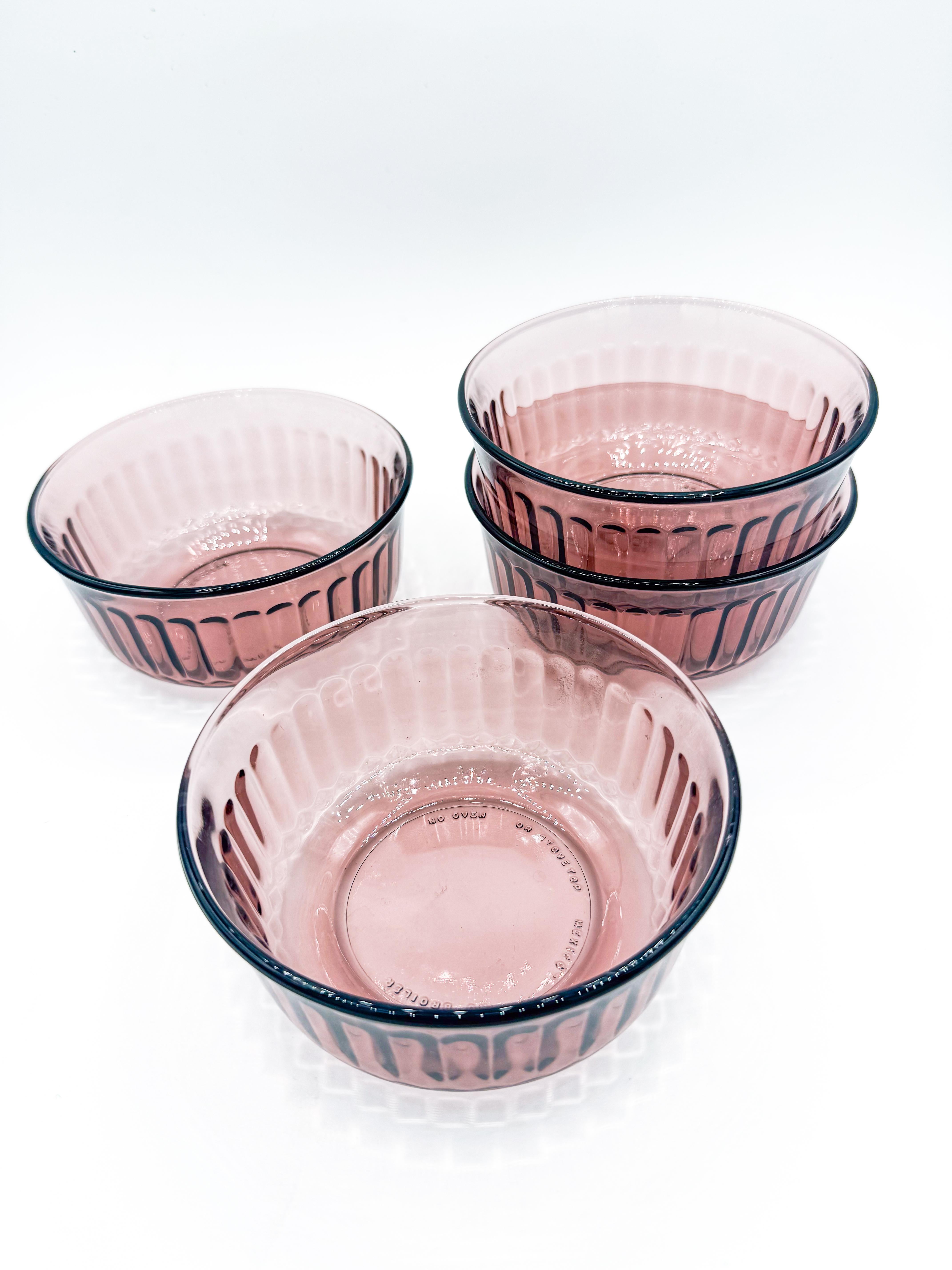 Add a touch of vintage elegance to your table with this beautiful set of four ribbed glass bowls in a striking amethyst purple hue. Made in Mexico, these bowls feature a transparent finish with subtle ribbed detailing that reflects light and adds
