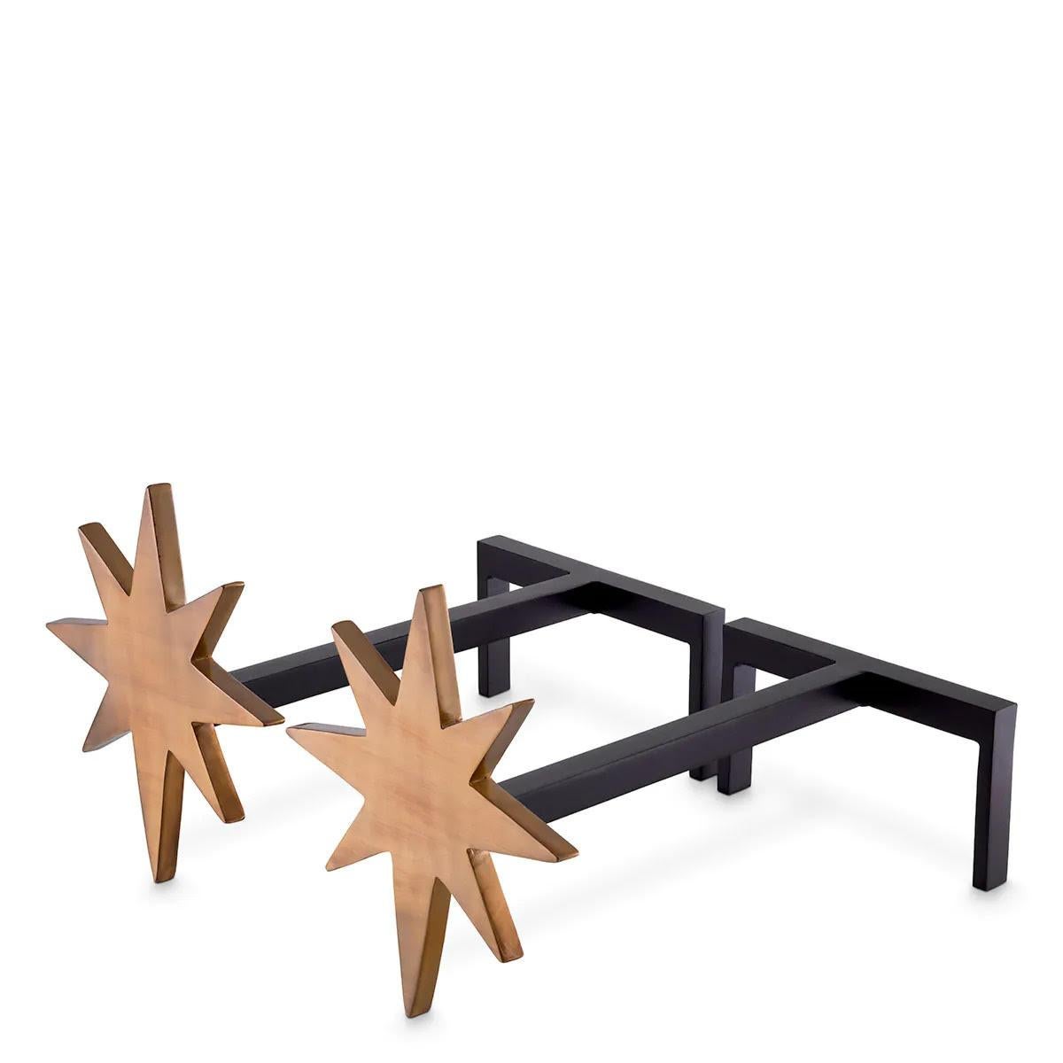 These andirons suit all styles of décor.
Made from wrought iron with a black and vintage brass finish, this elegant set of 4 fireplace tools features sturdy back rods and decorative star-shaped log guards. These functional fireplace accessories