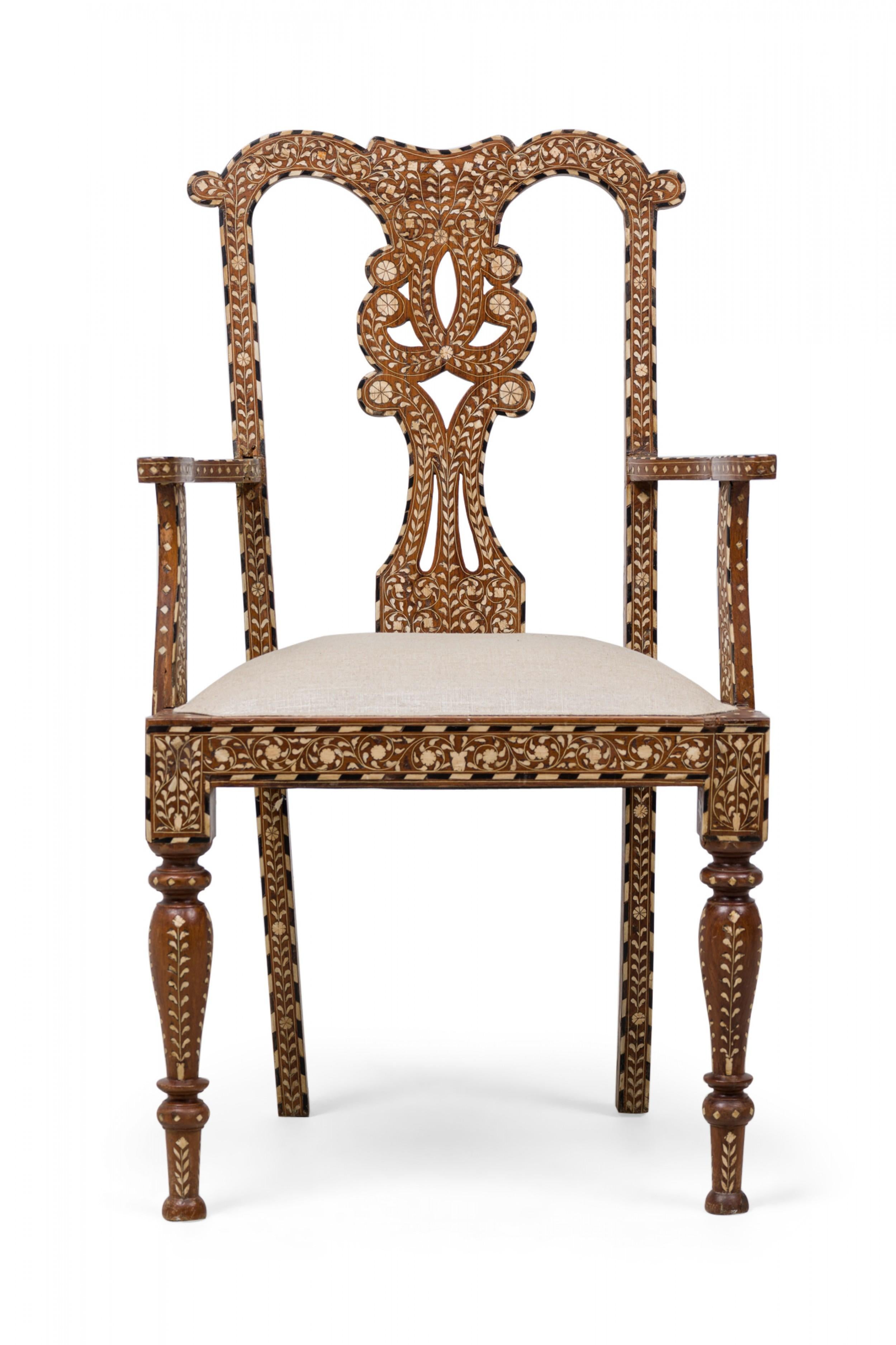 SET of 4 Anglo-Indian (19th century) carved hardwood armchairs with an openwork scroll form back, an inlaid scroll & foliate pattern between striped borders, beige upholstered padded seat, turned front legs and splayed back legs. (PRICED AS SET).