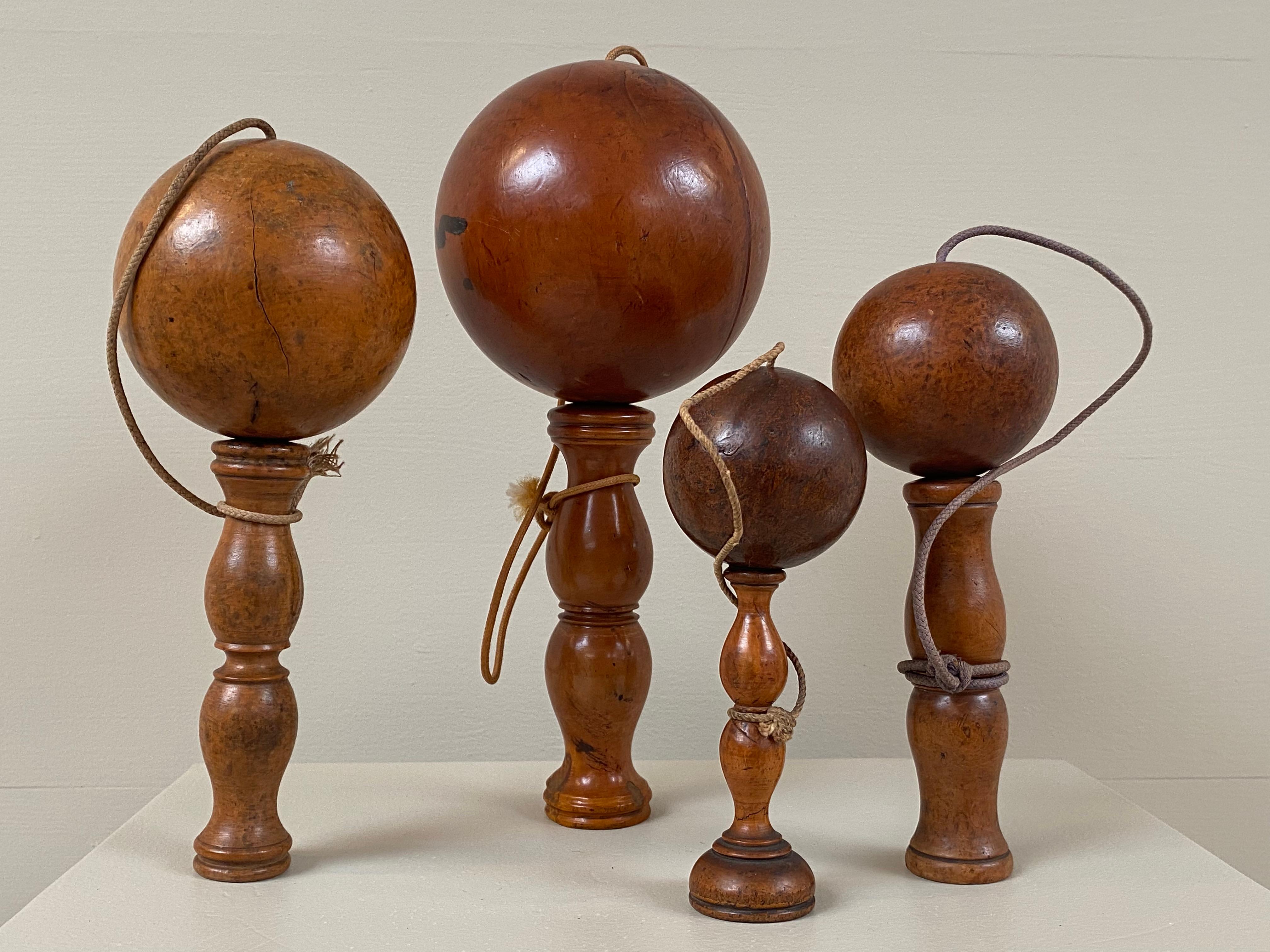 Beautiful set of four antique Bilboquets from France,around 1920,
cup-and-bowl children toys in turned Beechwood, dark tinted,
pretty patina,
a set full of charm and authenticity
warm and worn shine.
 