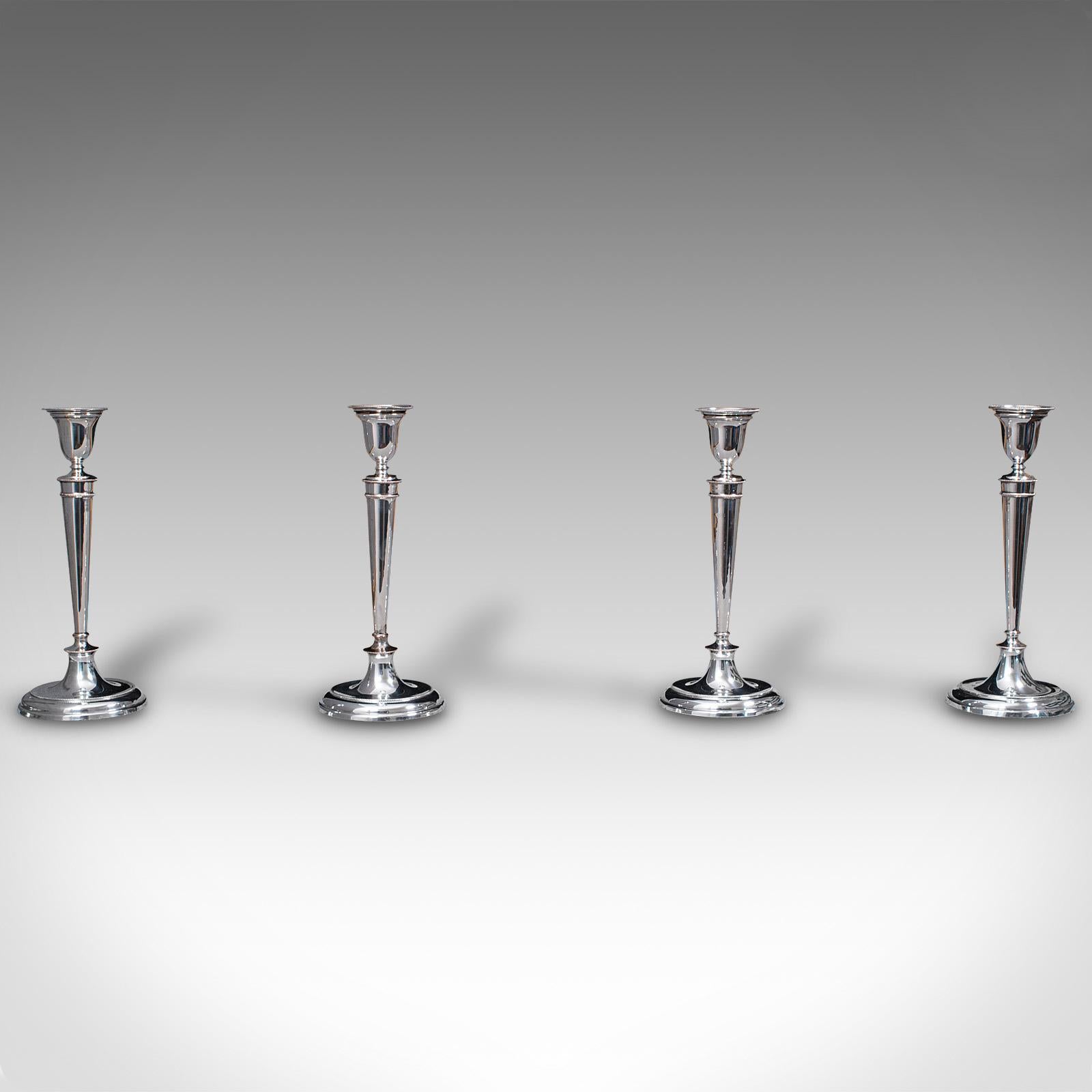 This is a set of 4 antique candlesticks. An English, silver plate candle sconce, dating to the late Victorian period, circa 1900.

Elegant candlesticks with bright appearance and fine detail
Displaying a desirable aged patina - some small marks