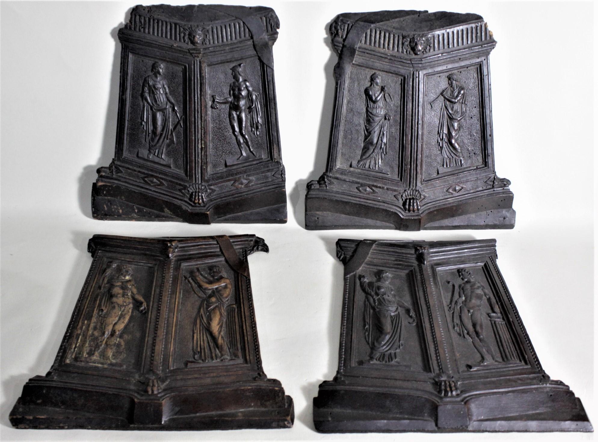 This set of four ornately carved wooden wall plaques may have been made for wall decoration, but are likely the raised front panels from the doors of an antique English cabinet. The stylized shield shaped panels show very detailed carvings which