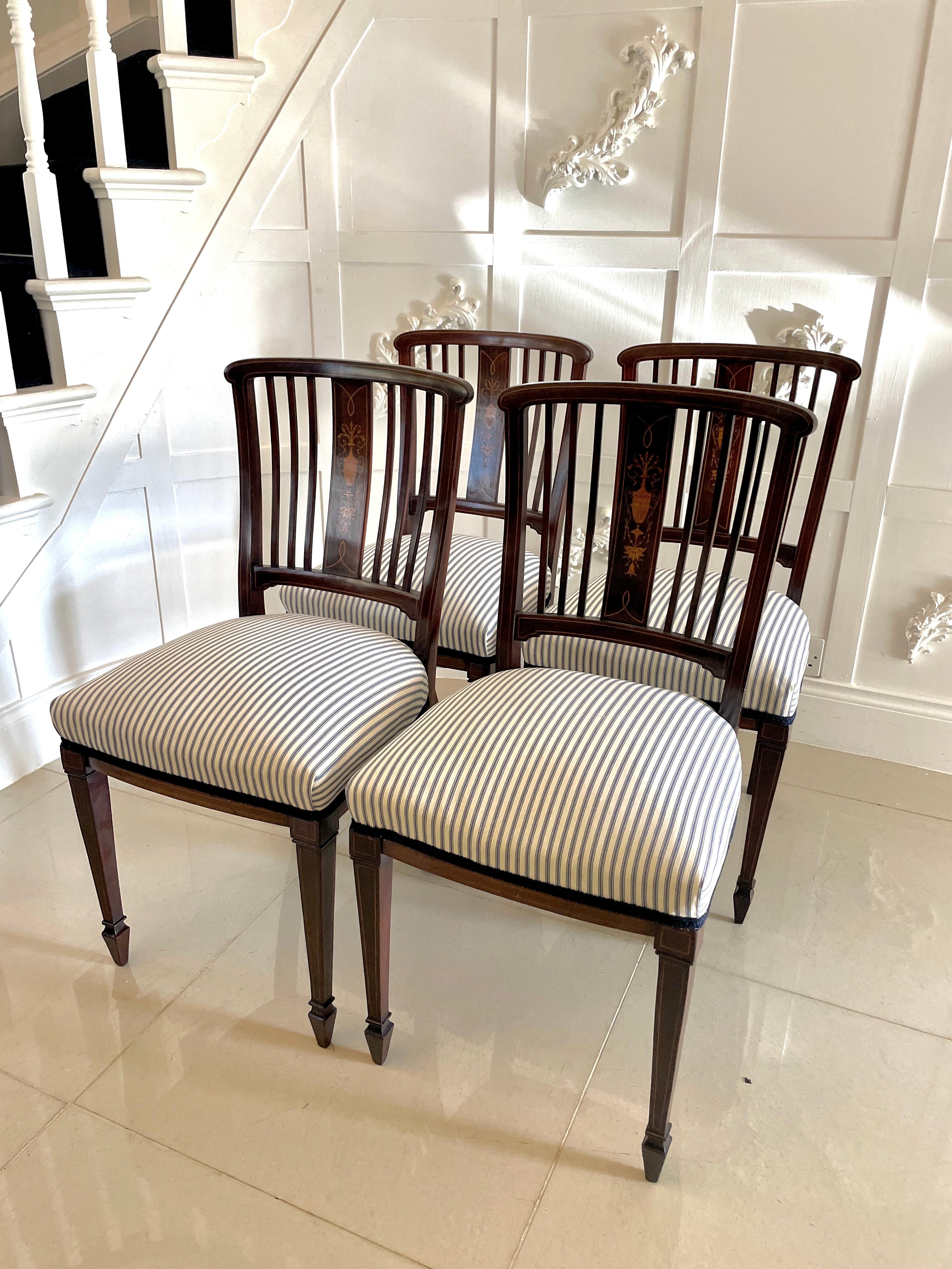 Set of 4 antique Edwardian quality mahogany inlaid dining chairs having a quality mahogany back with pretty marquetry inlay, newly reupholstered seats in a quality fabric standing on elegant square tapering mahogany inlaid legs with spade feet to