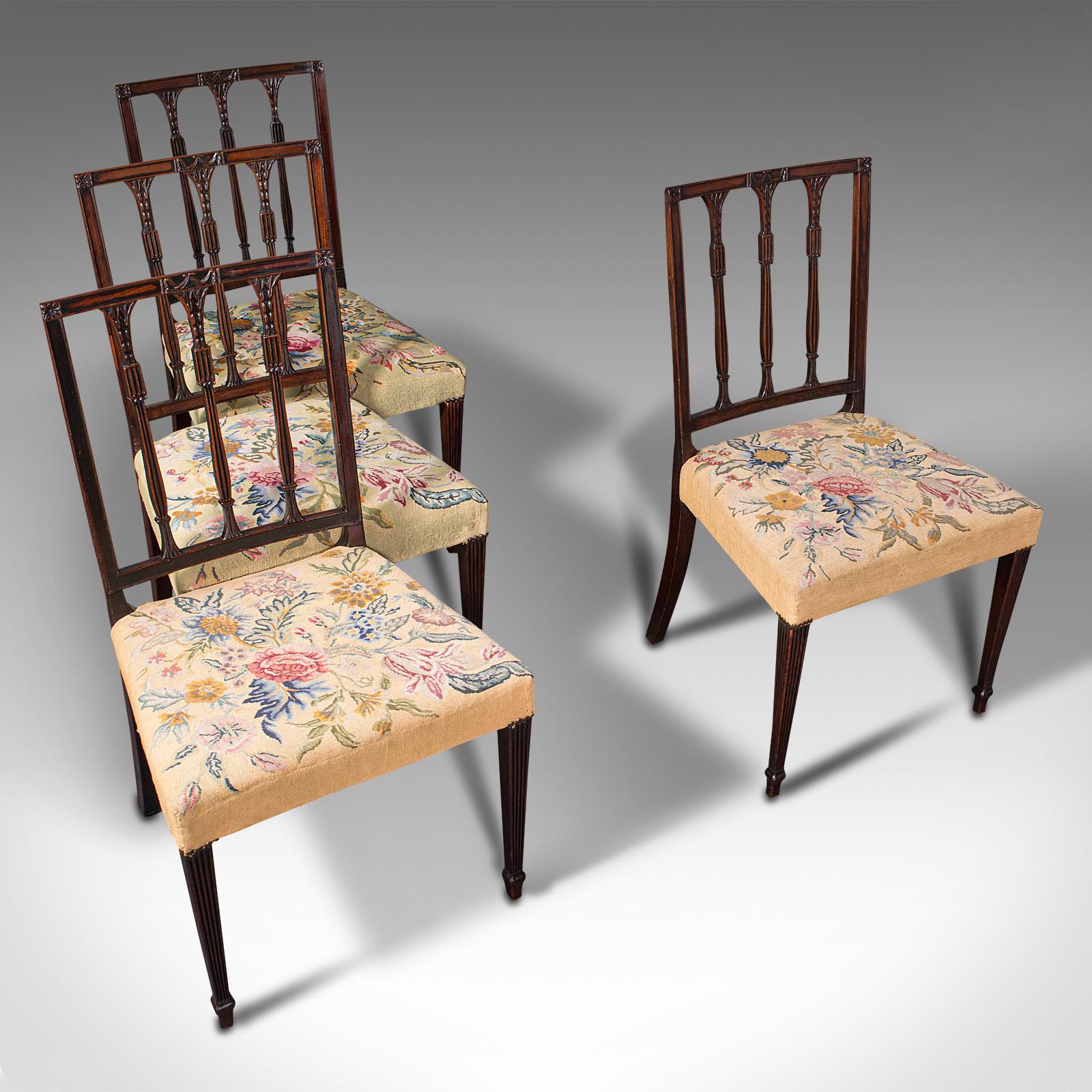 This is a set of 4 antique embroidered chairs. An English, mahogany dining seat in the Sheraton manner, dating to the Georgian period, circa 1780.

Delightful embroidered cushions and superb Georgian craftsmanship
Displaying a desirable aged