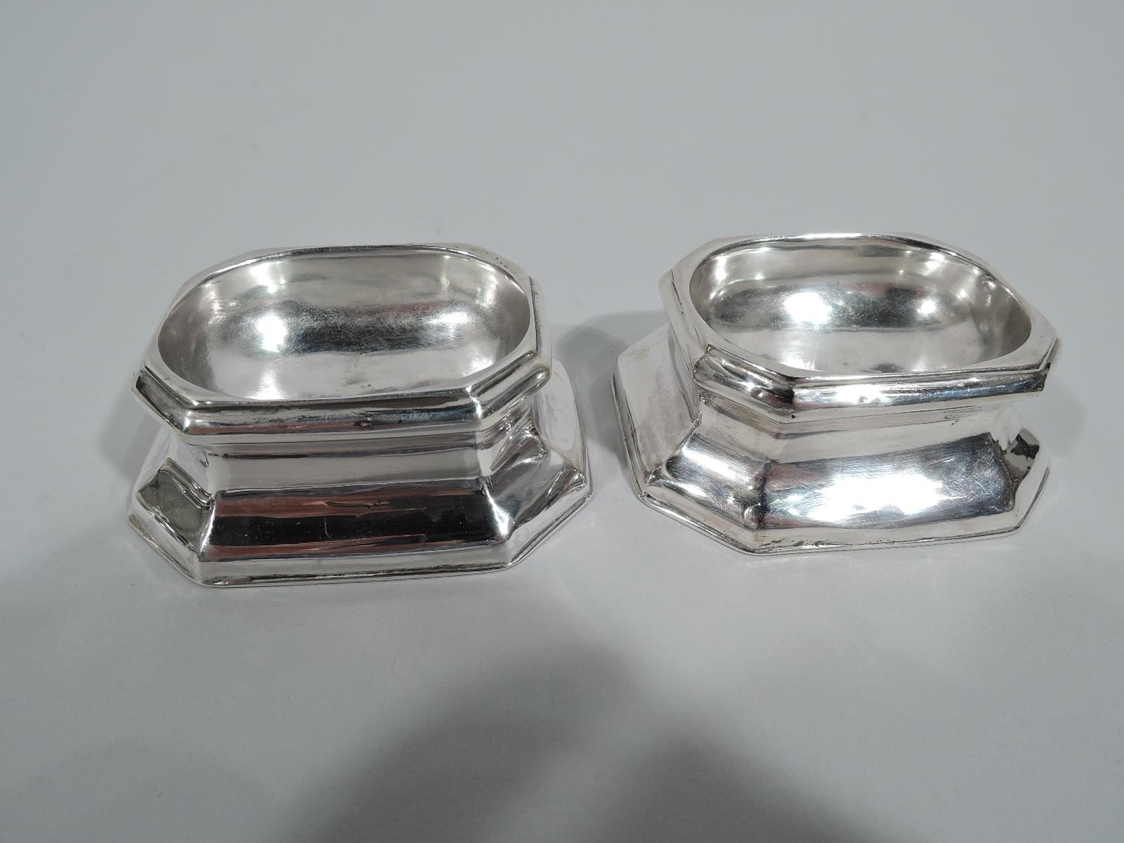 Set of 4 English Georgian sterling silver open salts, 1721-1732. Each: Oval well in spread rectilinear body with chamfered corners. An early version of the perennially popular form. Fully marked including London assay stamp, date letters for 1721,