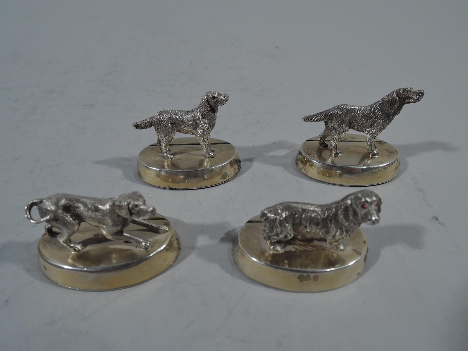 Set of 4 George V sterling silver place card holders. Made by Sibray Hall in London in 1922. Each: Cast canine figure mounted to oval gilt-washed base with slit. A canine medley. Each dog different as they are in real life. For a special “pack”
