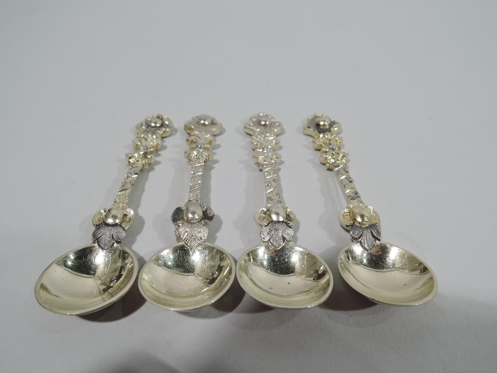 Set of 4 Victorian gilt sterling silver salt spoons. Made by William Edwards in London in 1872-3. Each: Shaft studded with bead and leaf base. Terminal shaped with central bead. Verso has stylized leaf mount. Round bowl. Fully marked. Total weight: