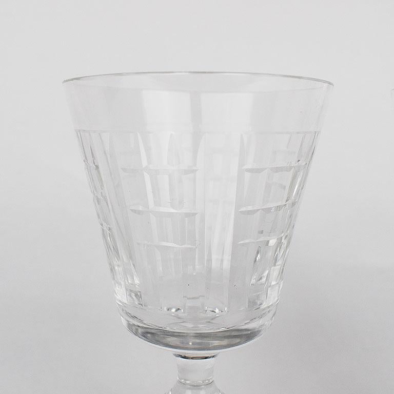 Set of four etched crystal glasses. Each glass is very delicate with a beautiful rectangular pattern around the rim. They would make a fantastic addition to a holiday or special occasion place setting. They could be used as wine glasses or water or