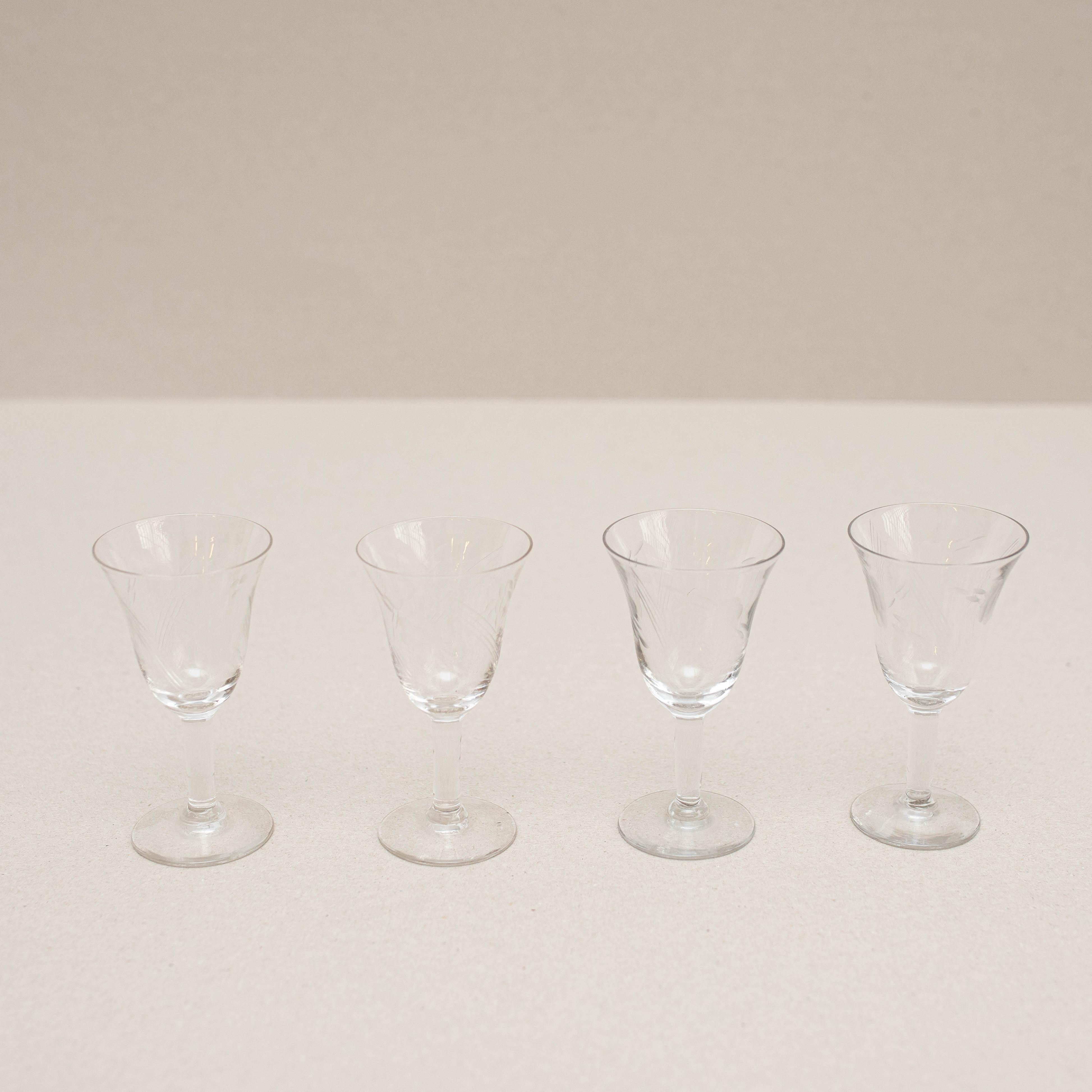 Set of 4 antique glass wine cups.    Made by unknown manufacturer in Spain, circa 1940.    In original condition, with minor wear consistent with age and use, preserving a beautiful patina.    Materials:  Glass    Dimensions:  H 11.30cm   Ø 6cm.    
