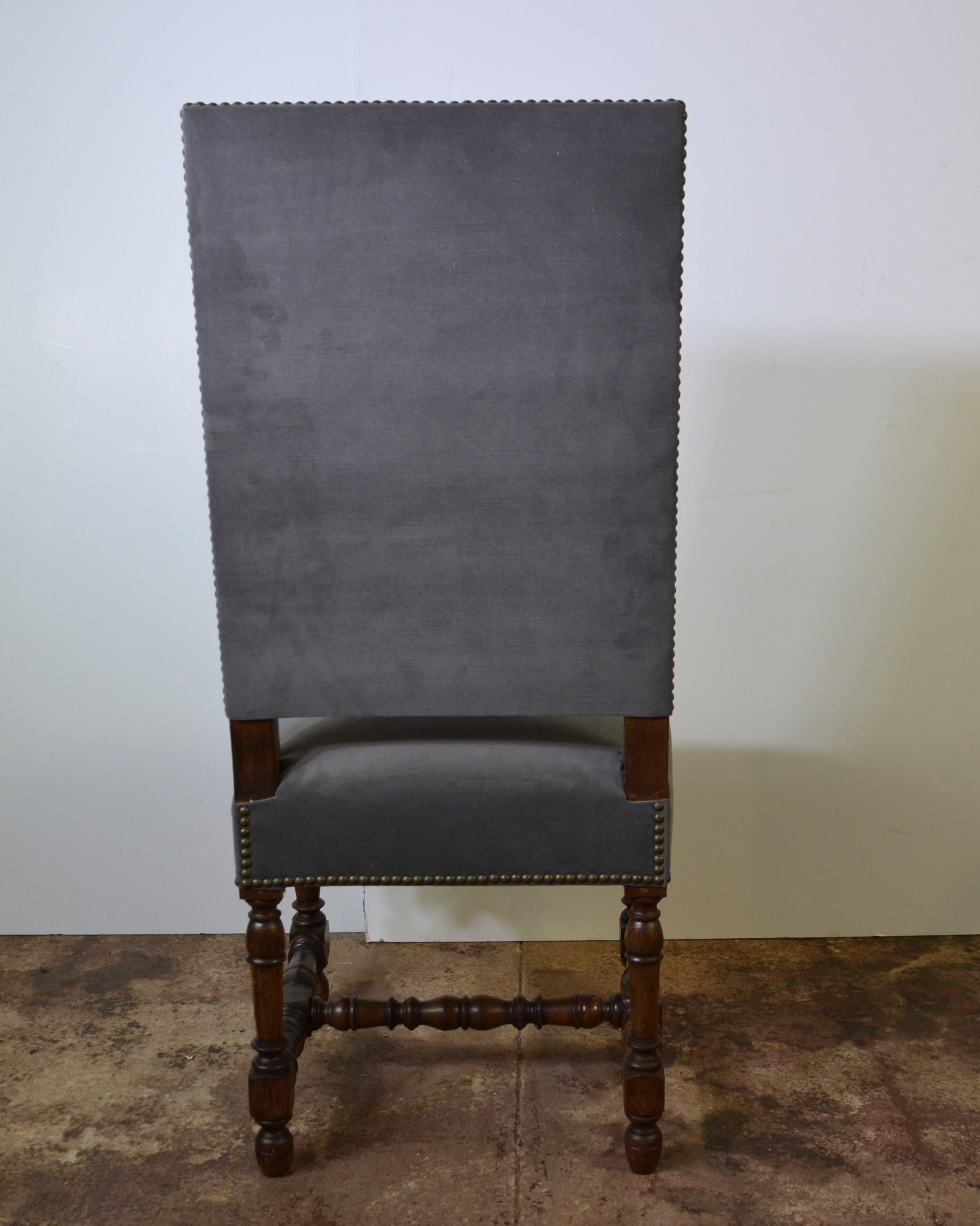 A good quality set of 4 antique upholstered high back dining chairs. Quality frames with Bobbin style turnings of good quality. Newly upholstered in a neutral fabric with brass studs. Walnut stained beech-wood.
