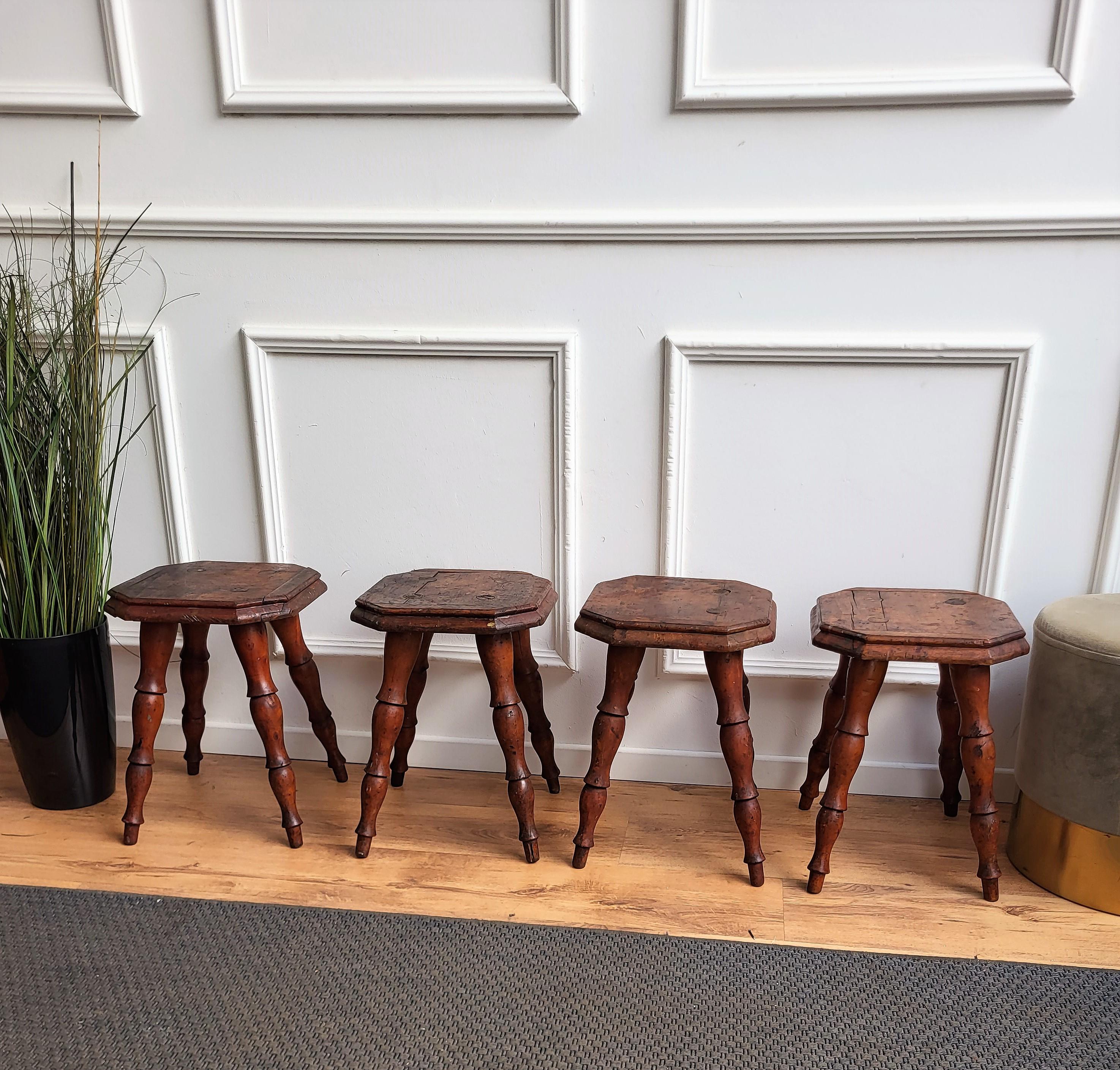 Beautiful set of 4 antique Italian solid walnut side tables or stools with squared and beveled seat or top standing on four beautifully carved legs. This Italian walnut stools or side coffee tables, with the rich and beautiful patina would look