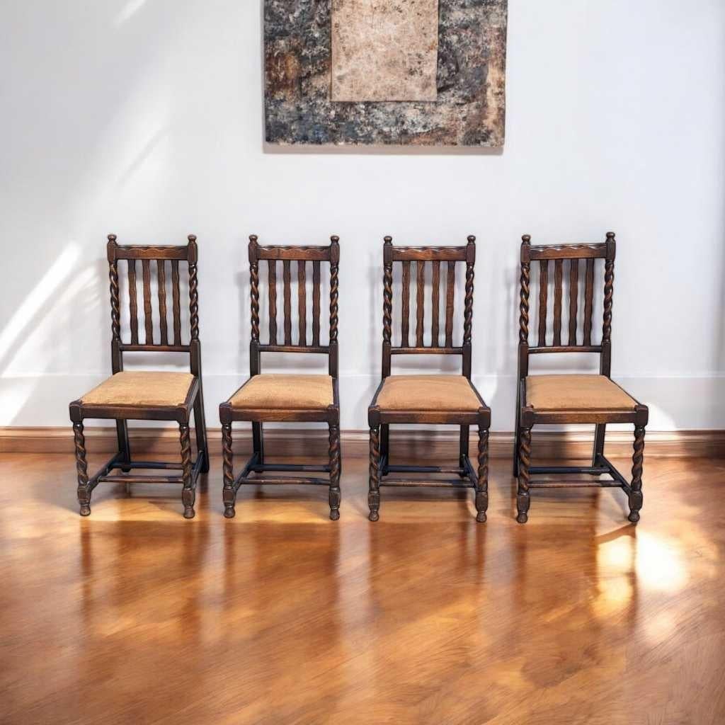 A distinctive set of four antique dining chairs in the classic English countryside tradition, crafted from solid wood and showcasing barley twist legs with velvet seats. These chairs combine timeless form and functionality—ideal for a traditional