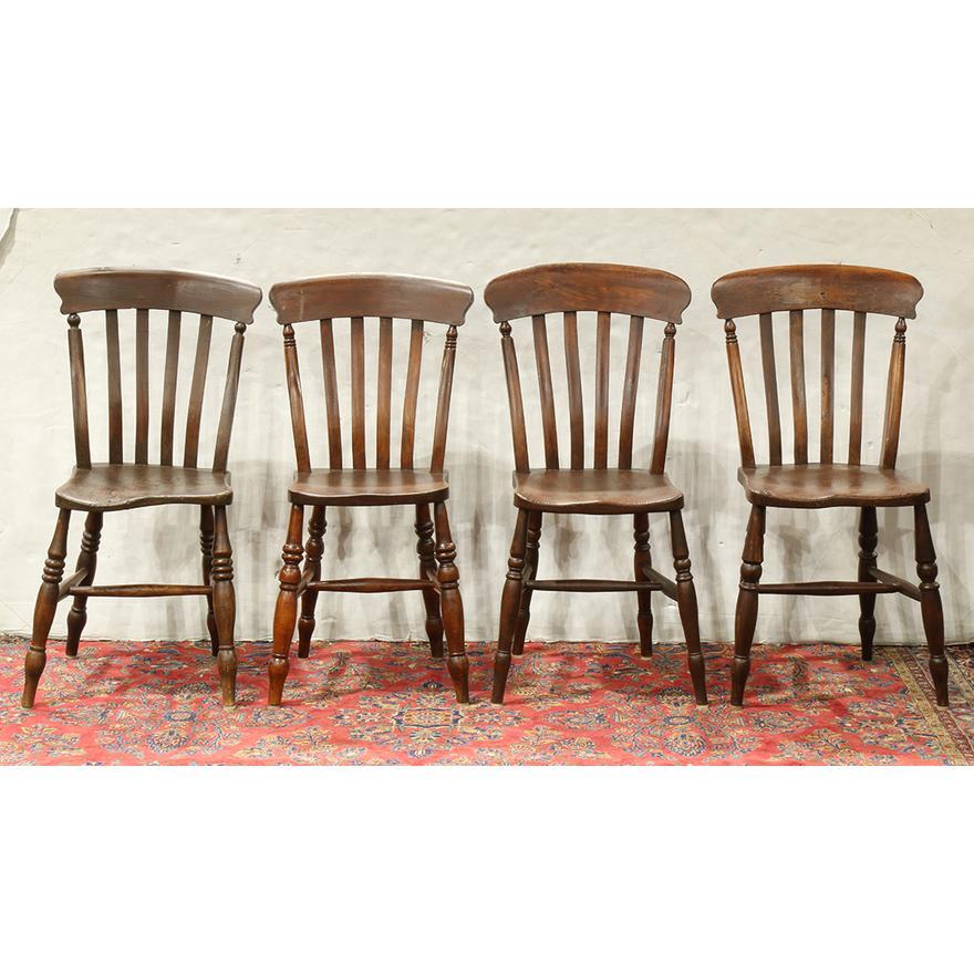 Set of 4 Late 18th Century American Colonial side chairs circa 1750, having a contoured back with vertical splats, a carved seat and rising on turned legs. Chairs retain their original finish. 36