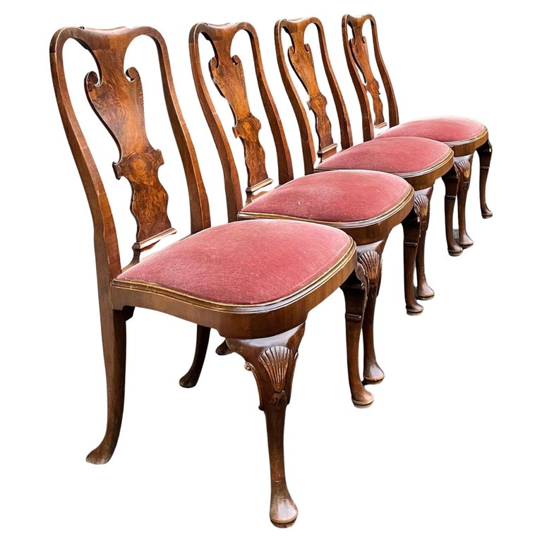 Beautiful set of four authentic dining chairs Queen Anne high back. Shaped back, carved shelves details on the legs and pink upholstery.

 