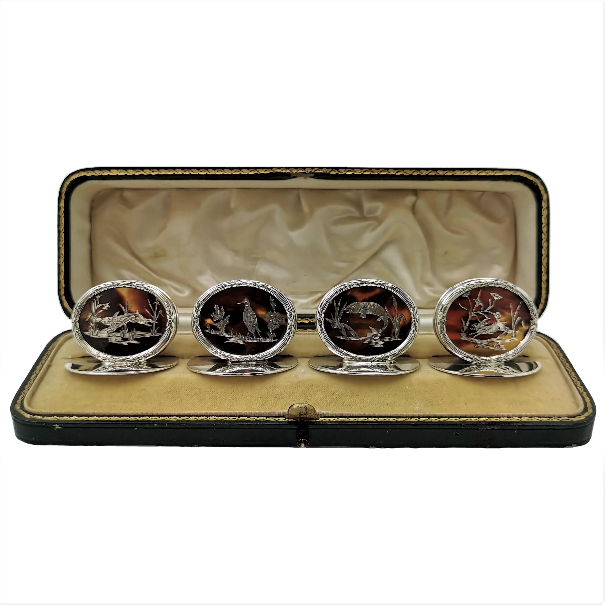 A set of 4 beautiful Antique Sterling Silver & Tortoise Shell Place Card Holders each with a unique inlaid silver image of hares, a leaping fish & a game bird. These Menu Holders have oval forms on oval bases and the faces have foliate and reeded