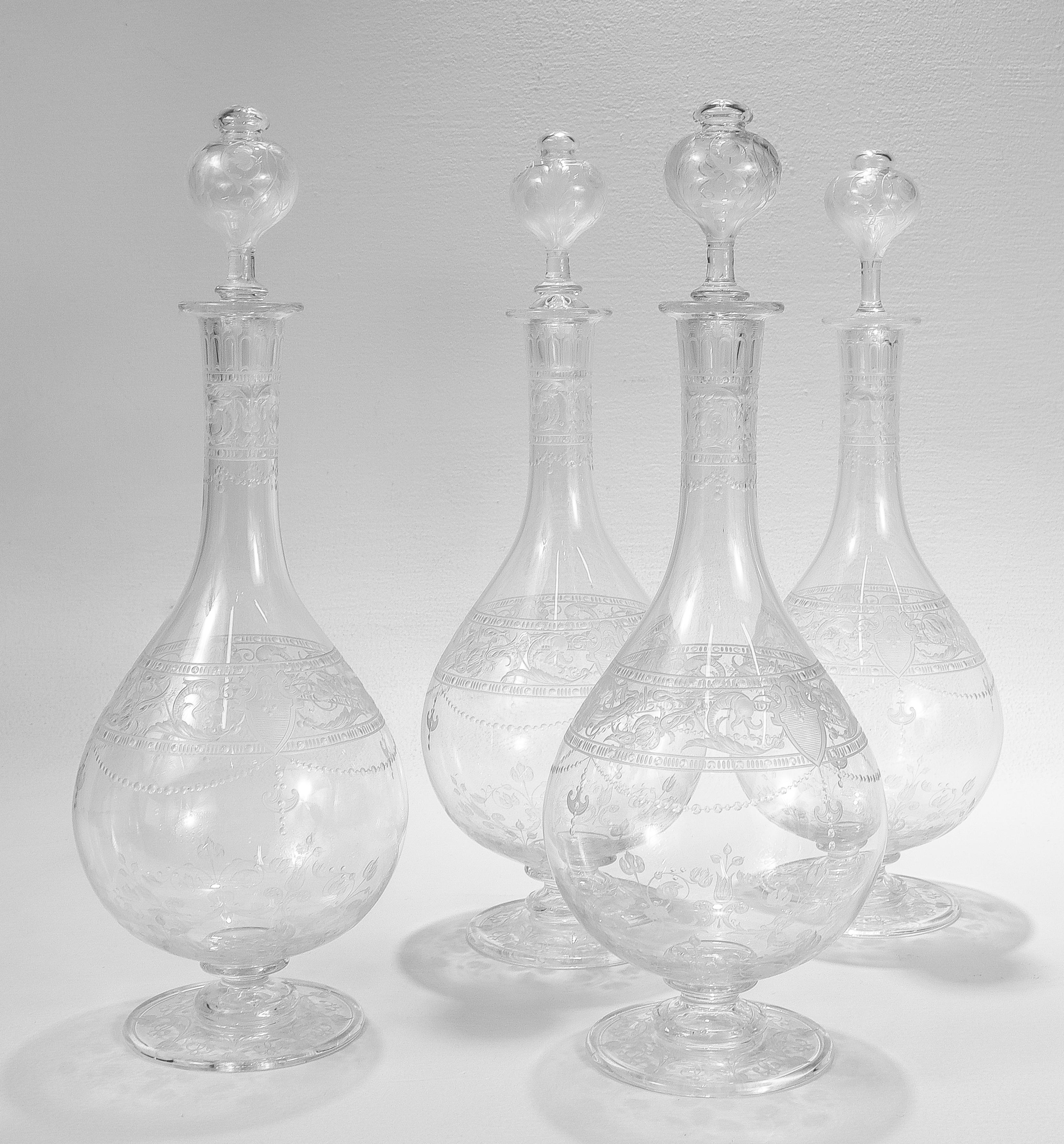 A fine pair of antique English etched and engraved glass decanters.

Attributed to Stevens & Williams or Webb.

With engraved & etched designs trelliswork, flowers, and shield devices.

Each with a stopper with cut leaf motifs. 

The