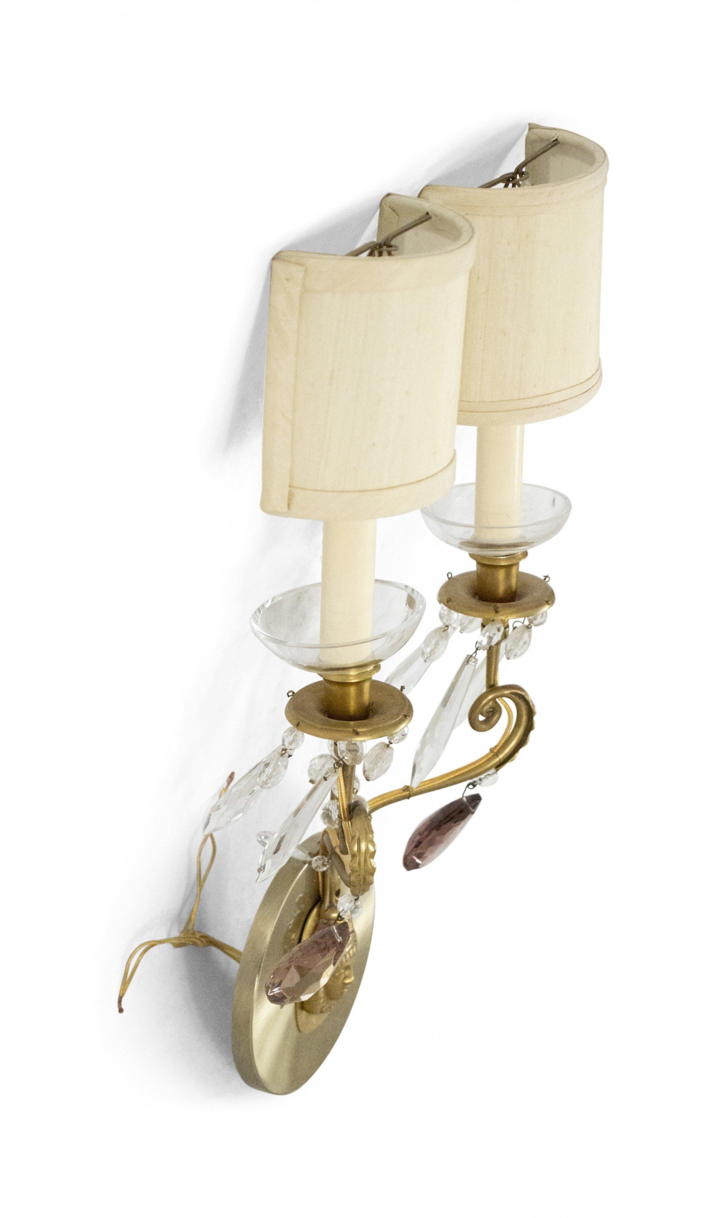 Set of 4 Swedish (1910) Neo-Classic style brass wall sconces with mask design on the central back plate, white and purple crystals, and two lights with clip on beige fabric half shades. (PRICED AS SET).