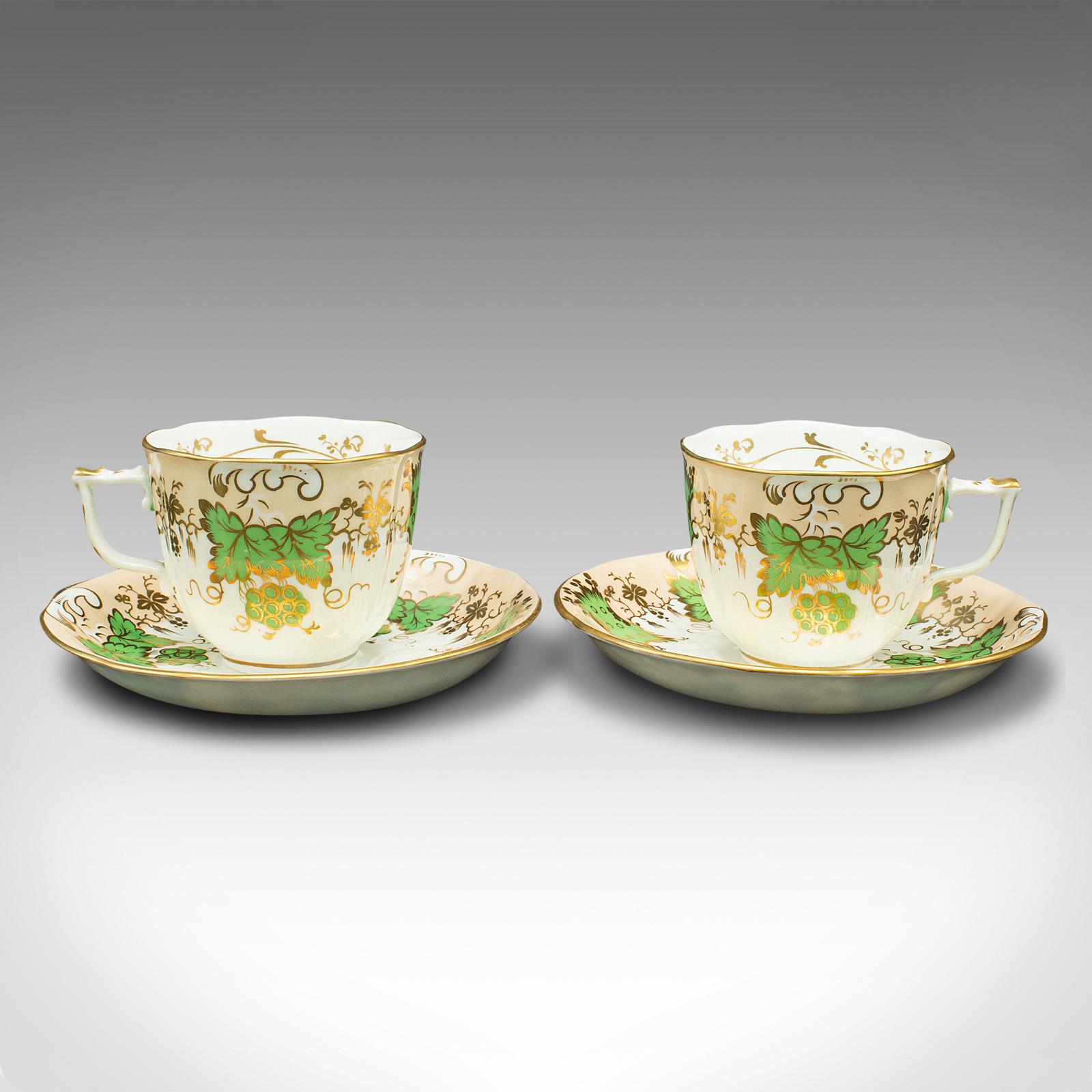 This is a set of 4 antique tea cups. An English, bone China decorative cup and saucer with green grape pattern, dating to the Victorian period, circa 1850.

A joy to hold, and beautifully decorated with Victorian appeal
Displaying a desirable aged