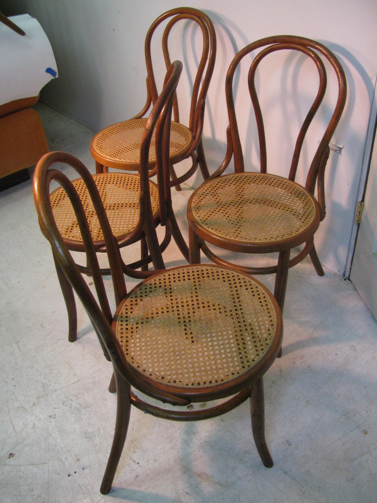 Only one pair available. Pair of bentwood dining chairs crafted from oak with caned seats. Lightweight and very sturdy, chairs have been re-caned in the last few years.