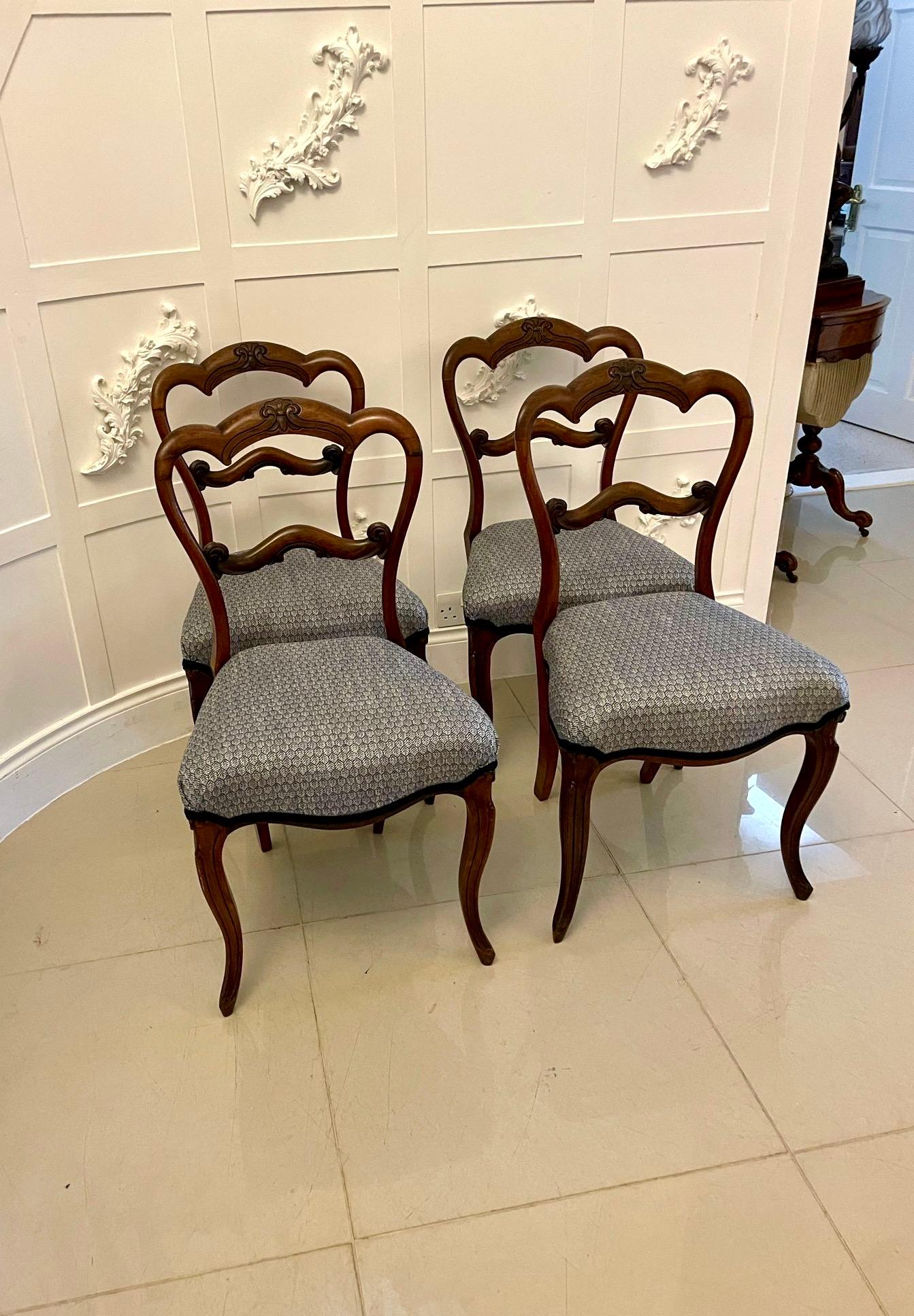 Set of 4 antique Victorian quality rosewood dining chairs having a shaped carved top rail with a shaped carved centre splat newly, reupholstered serpentine shaped seats in a quality blue fabric standing on shaped cabriole legs to the front and out