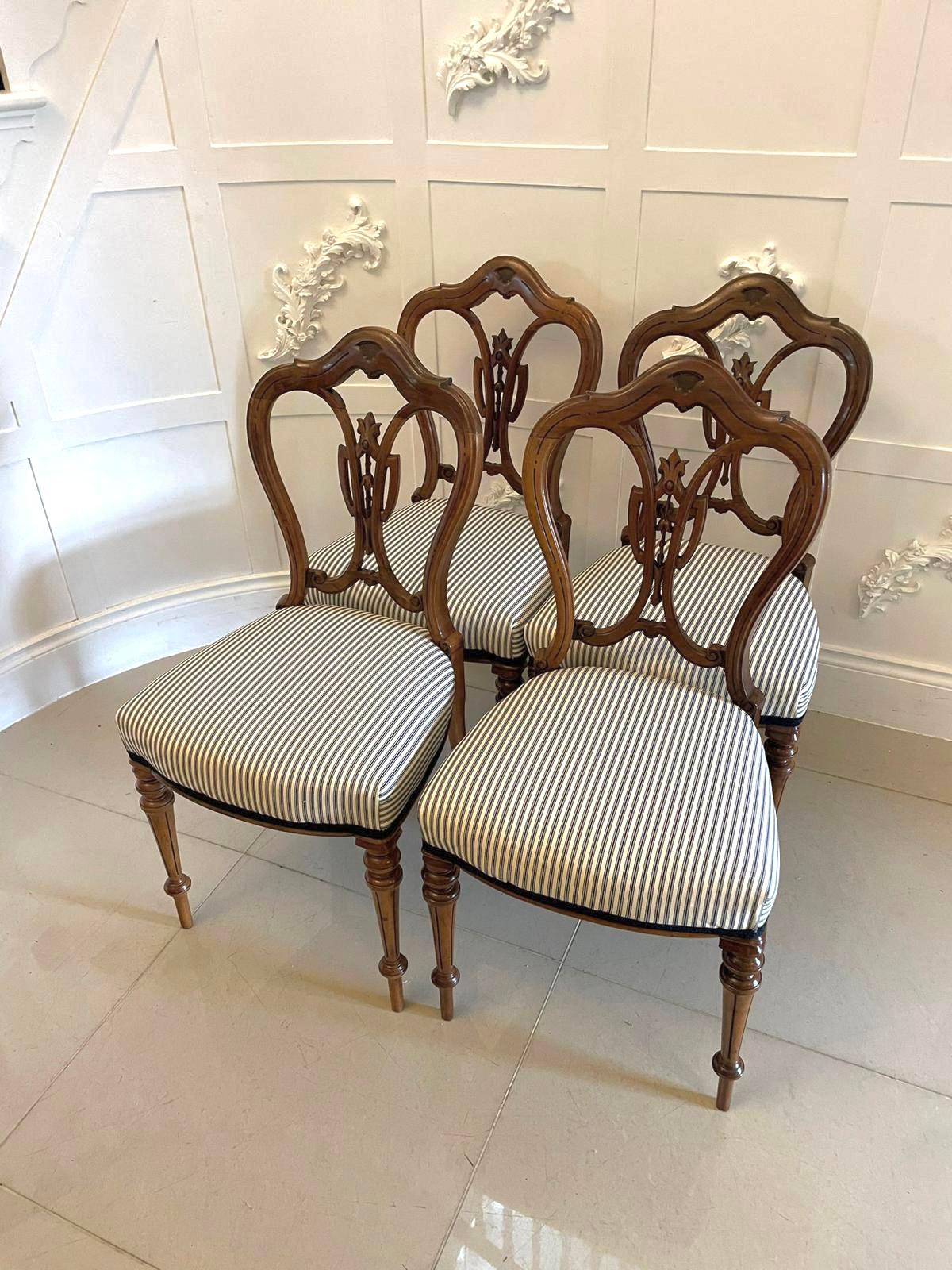 Set of 4 antique Victorian quality walnut dining chairs having an outstanding shaped carved top rail quality carved walnut shaped splat to the centre, newly reupholstered seats in a quality fabric standing on elegant turned tapering reeded legs to
