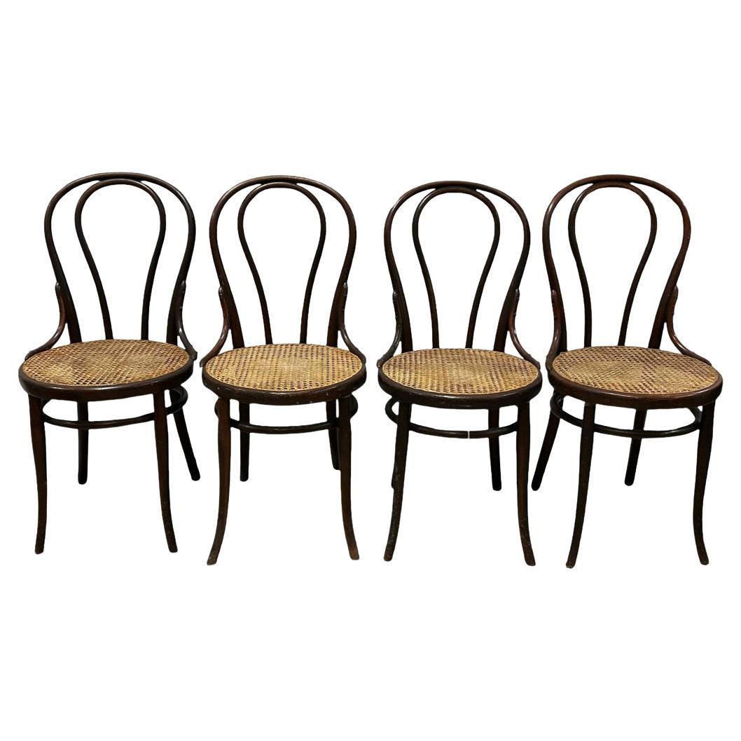 Set of (4) Antique vintage cane seat cafe chairs by Thonet gebrüder. model No. 18 chairs. They are in original condition with nice patina. The dark Brown Walnut wood has been oiled showing honest wear and ready for use. All Cane is in hand done and