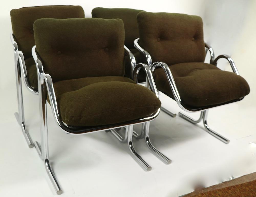 Sophisticated set of four chrome framed upholstered seat and back dining chairs designed by Jerry Johnson for Landes Furniture. Know as the Arcadia chair, circa 1970s these chairs are chic and stylish, while still being comfy, functional and sturdy.