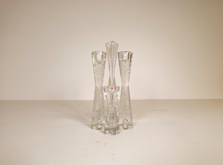 Group of 4 Iittala Arkipelago candlesticks in time glass high forms.
Architectural cast clear glass blocks.
 three of them with bubbles and one clear glass with more edge. They are created to appear as if they were blocks. They are designed by