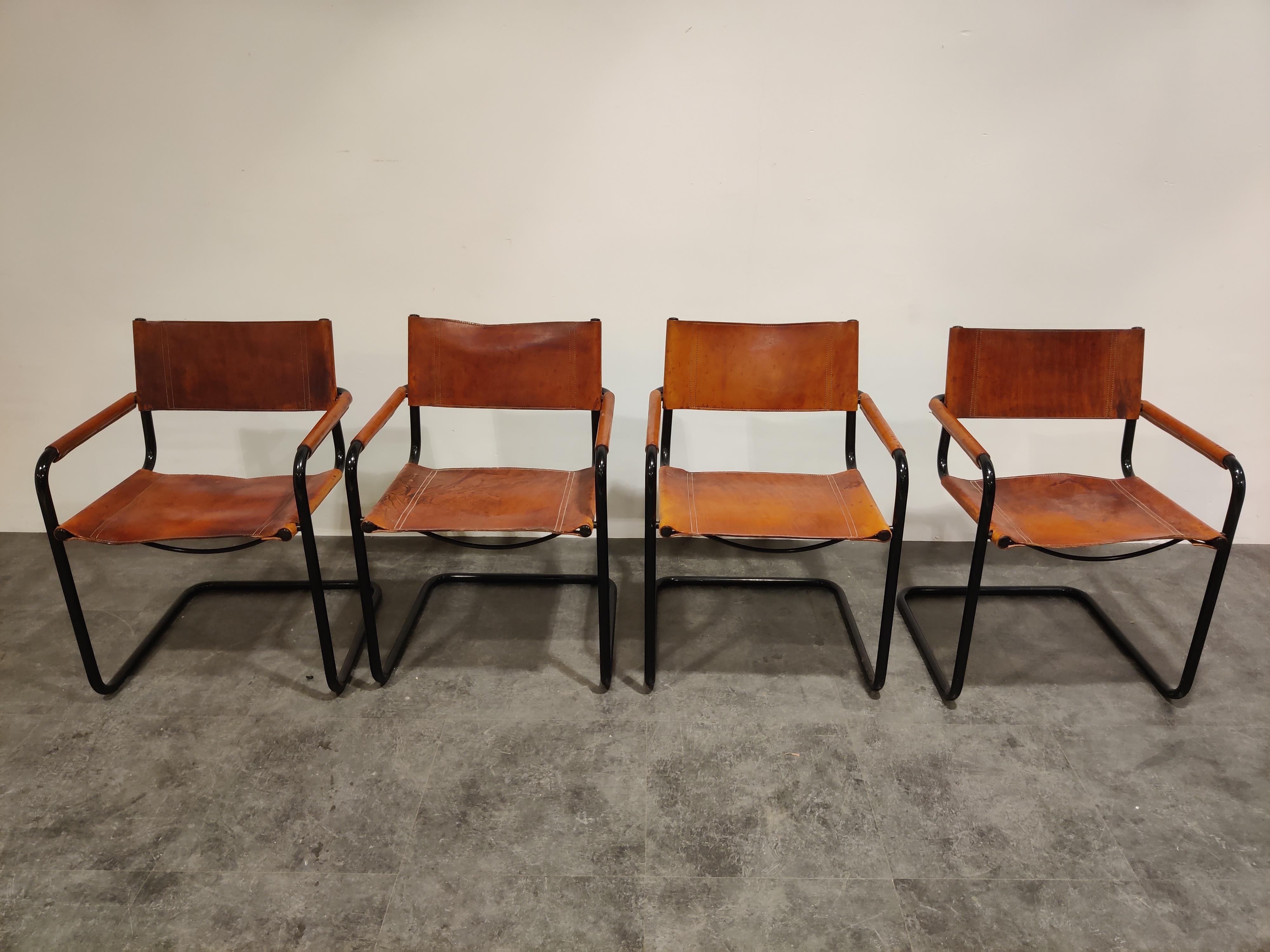 Vintage cantilever dining chairs or armchairs designed by Mart Stam in the 1930s.

These are 1980s editions produced by Fasem.

They come with thick and strong brown leather mounted on a black lacquered metal frame.

The chairs also have